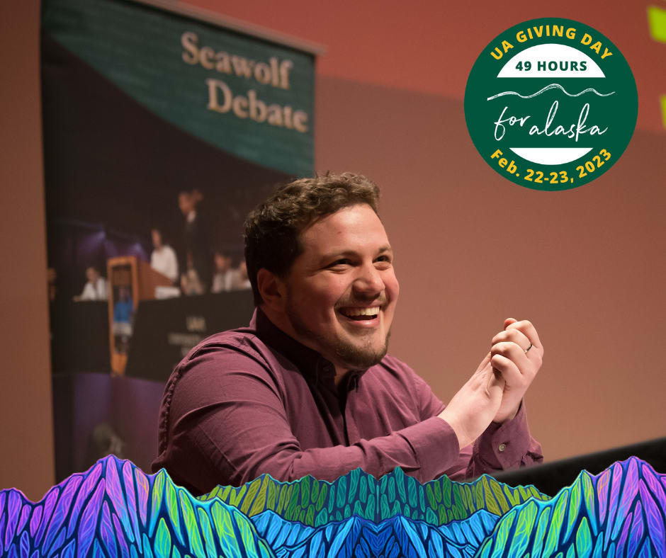 Seawolf Debate student, Hockema, at his debate table, clapping and celebrating a win!