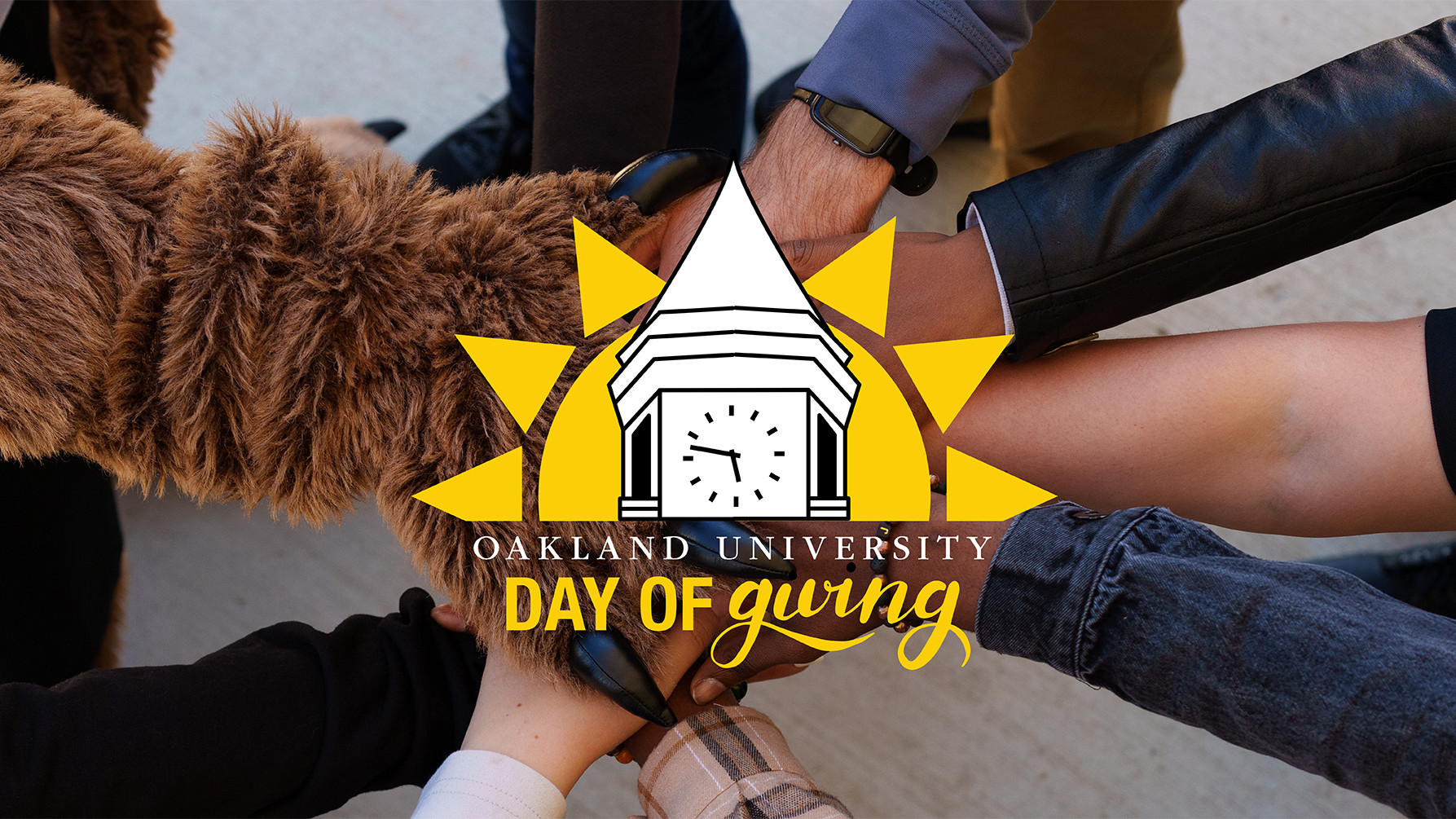 A group of hands gathered at the center of the photo with the OU Day of Giving logo on top.