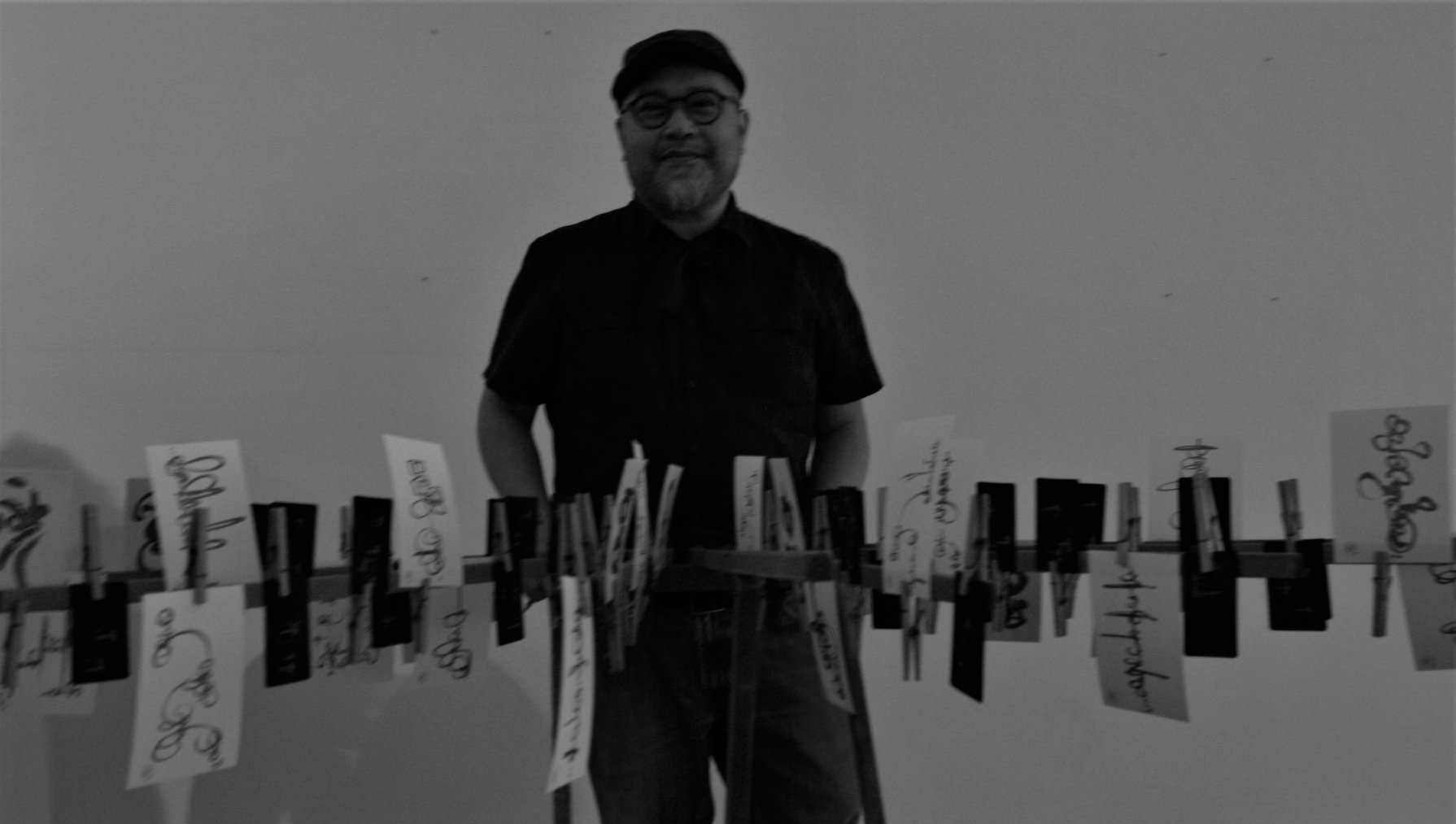 Sam Roxas-Chua poses with a portion of his visual arts exhibit at last year's festival.