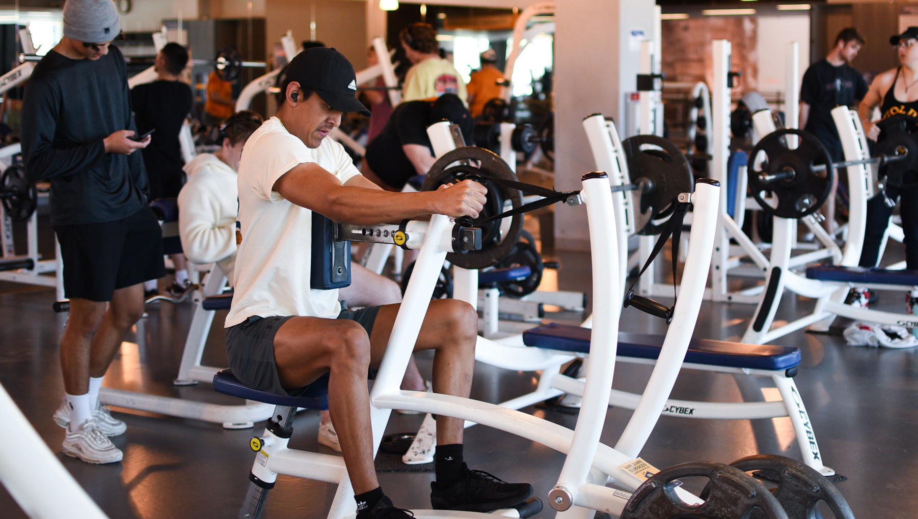 Individuals working out in weight room