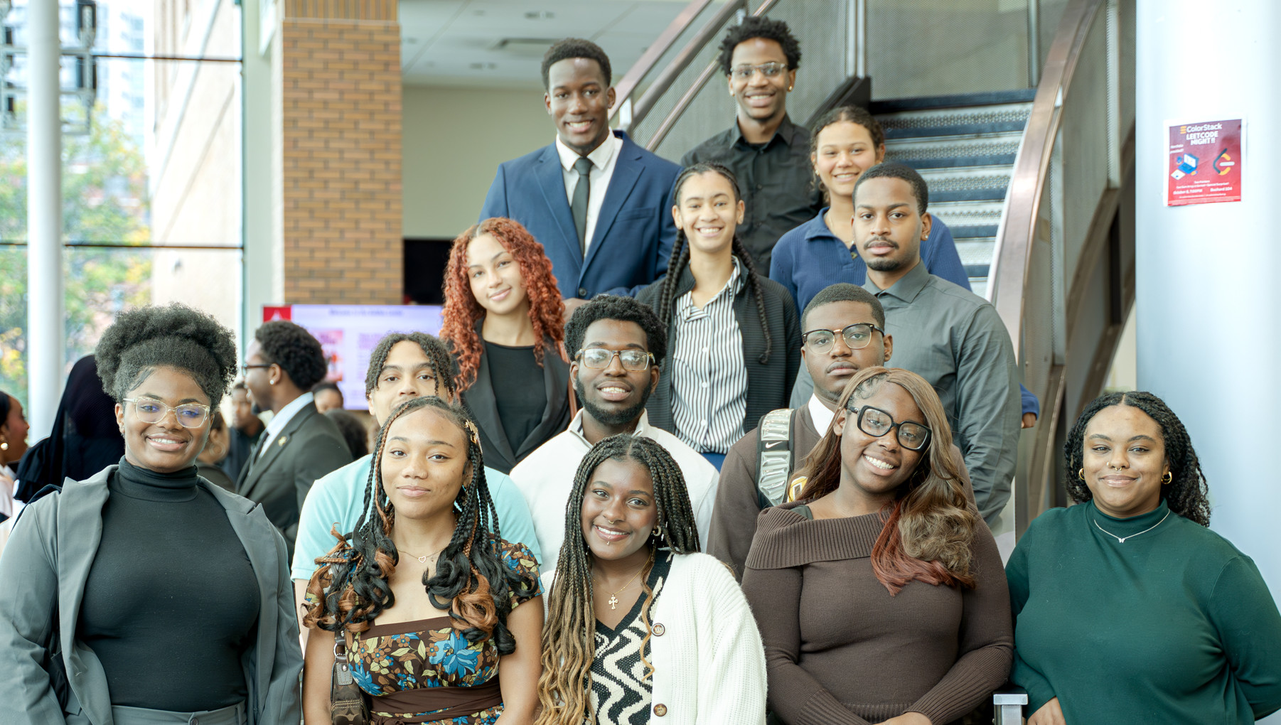 Group photo of NSBE students posing on staircase inside the college.