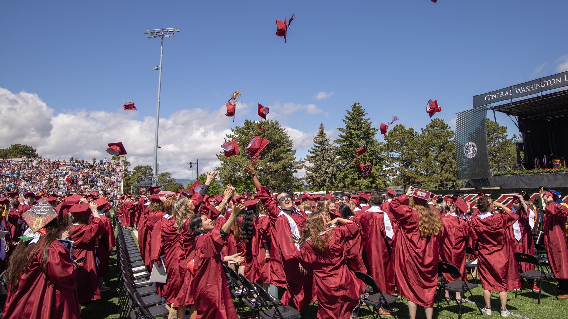 2022 Wildcat Grads throwing their caps in celebration!