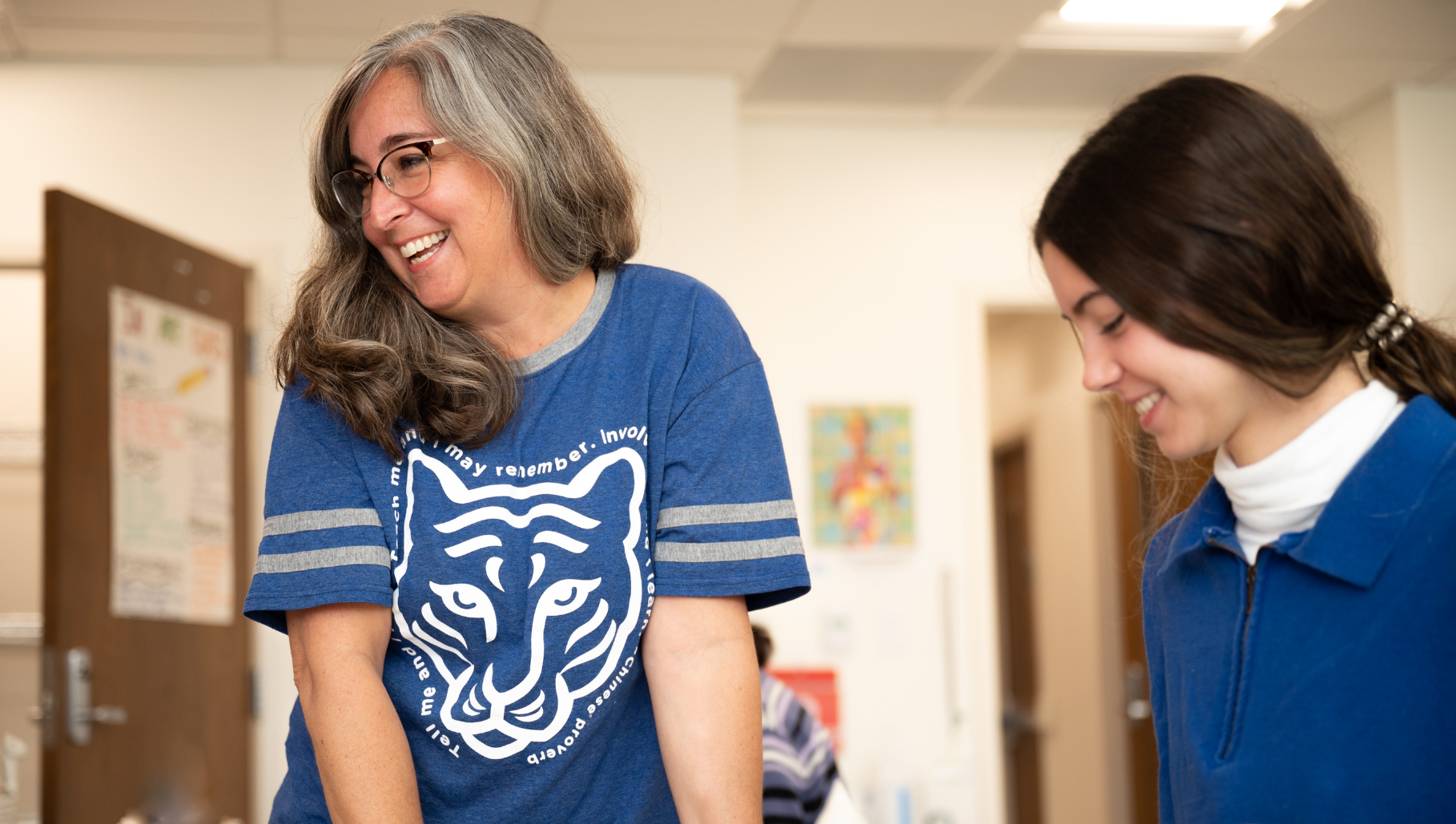 Teacher Laughing with Student