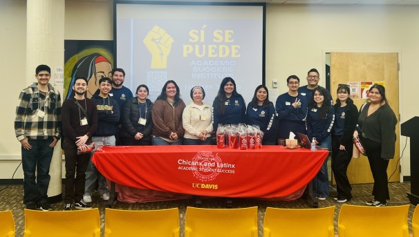 12 students and 2 career staff members smiling at the camera, lined up in El Centro.