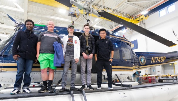 Students standing with a helicopter