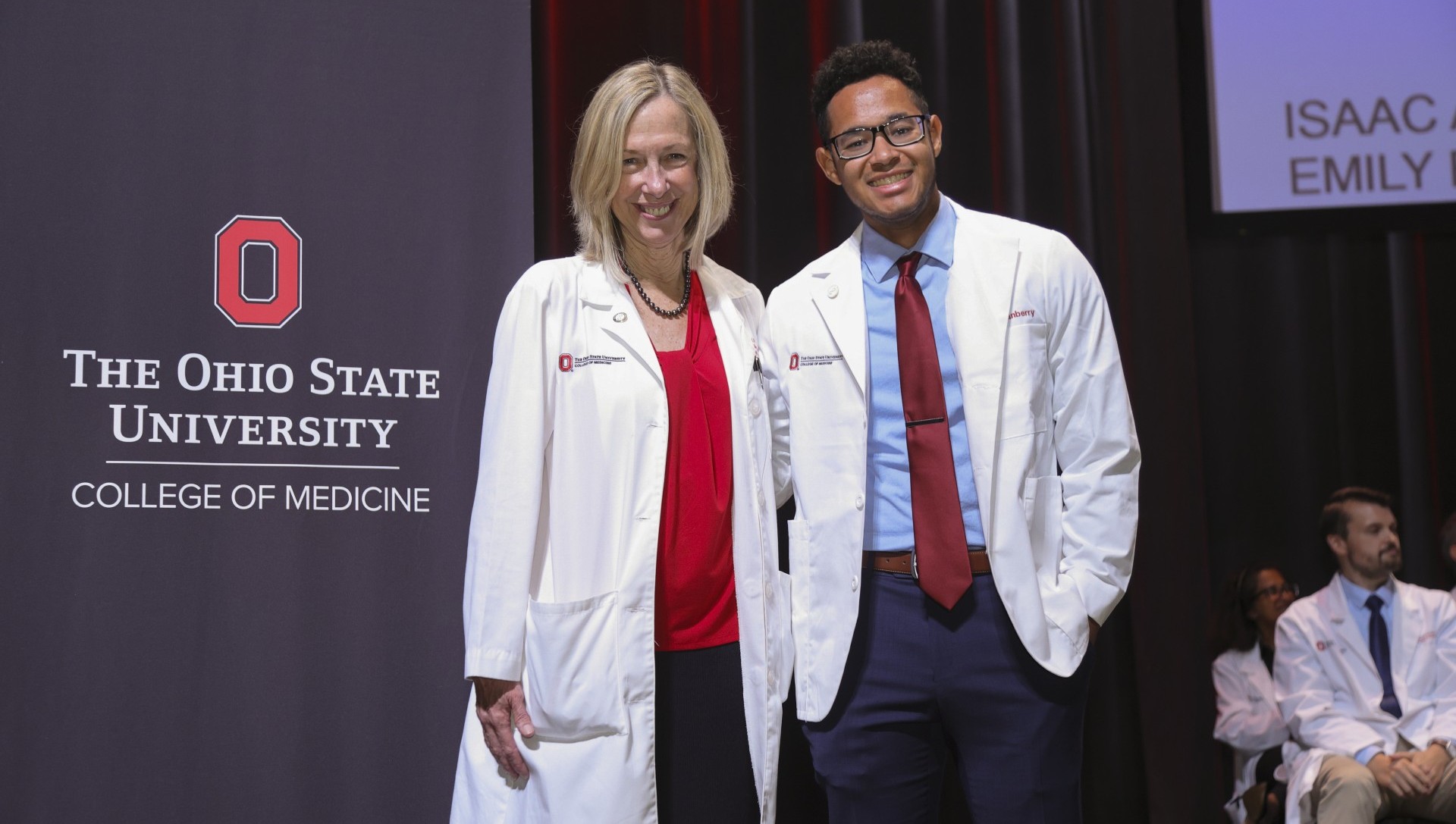 Two doctors standing on stage