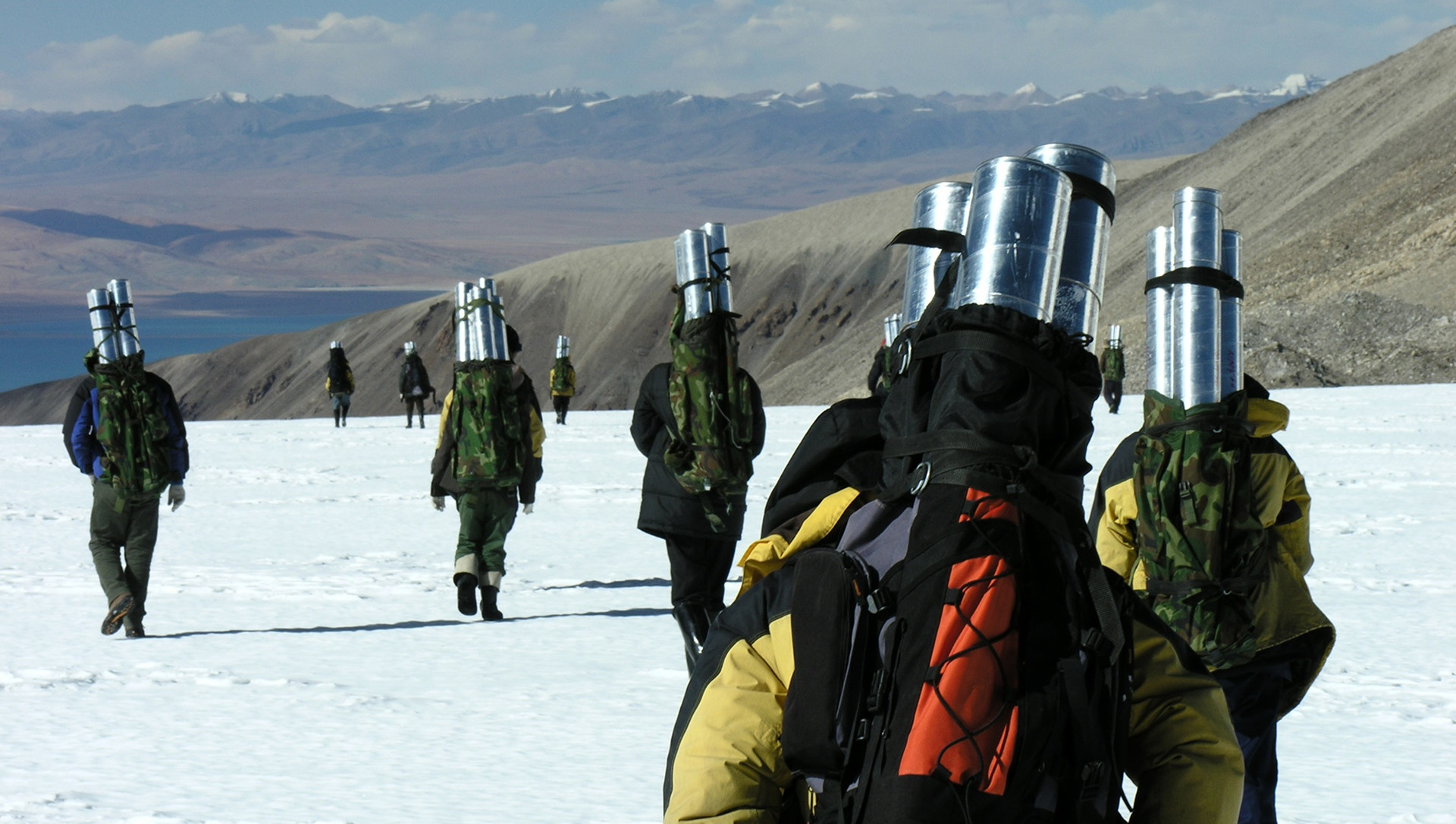 Byrd Center researchers carry ice cores through a open, snowy field