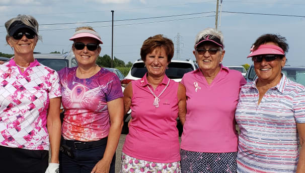 Five golfers standing in a parking lot for the Stefanie Spielman Fund for breast cancer research