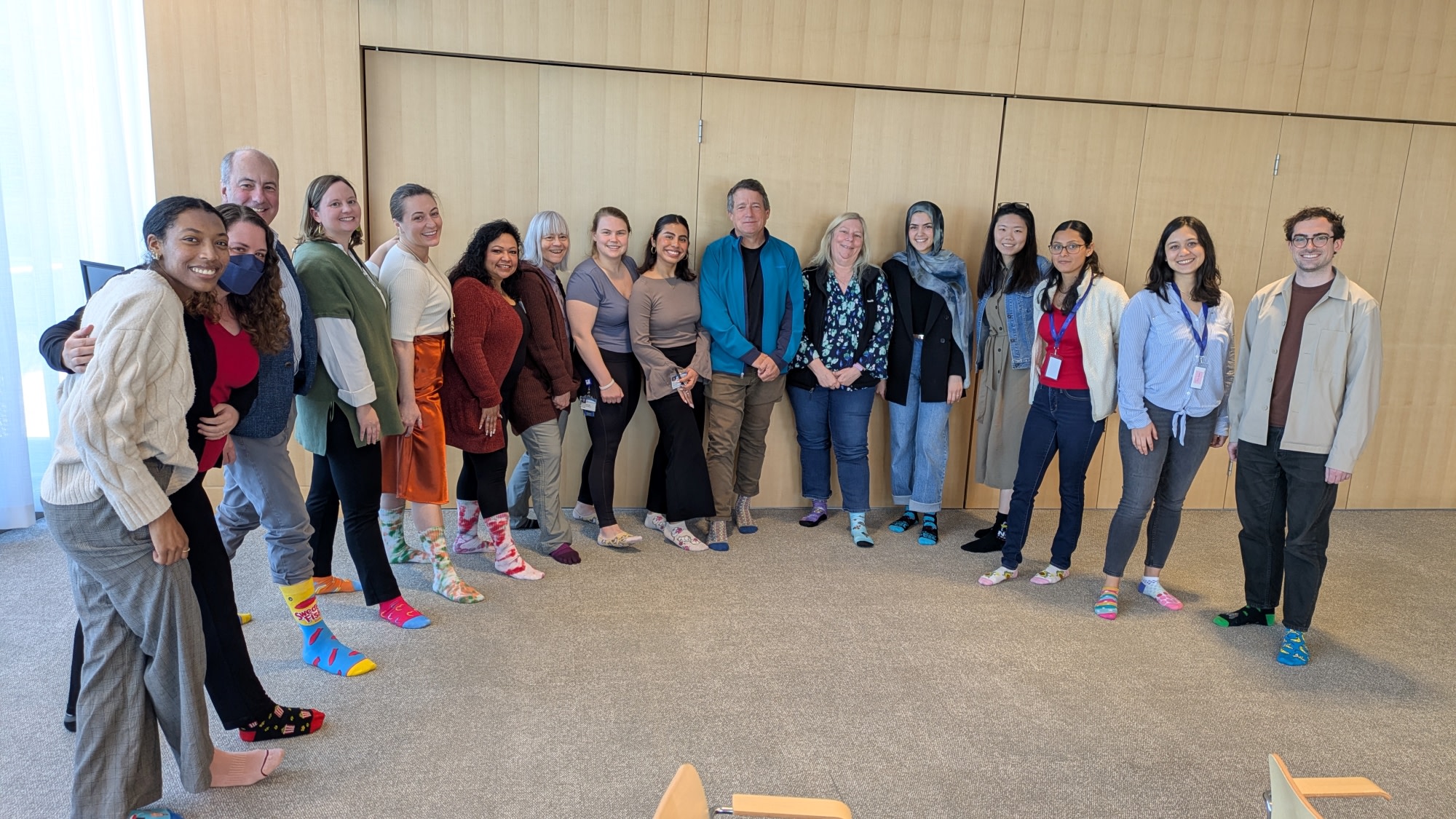 Members of the Center posing with mismatched socks