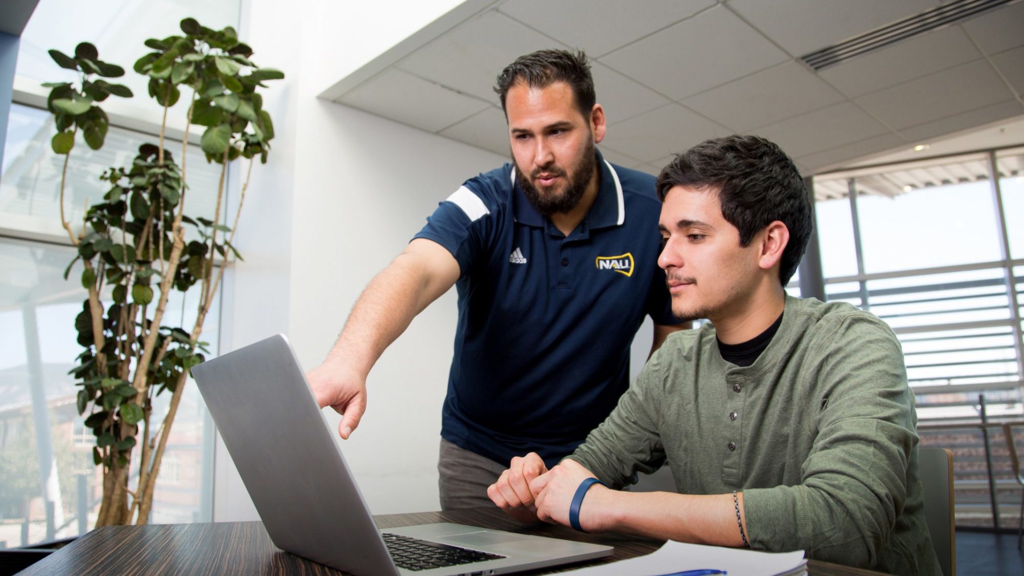student is being helped by an adult female.