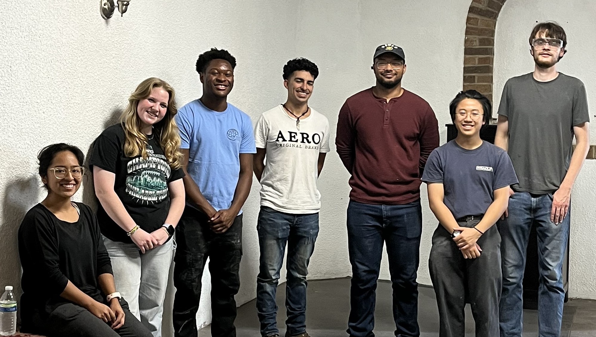EWB students in group photo from project to restore building.