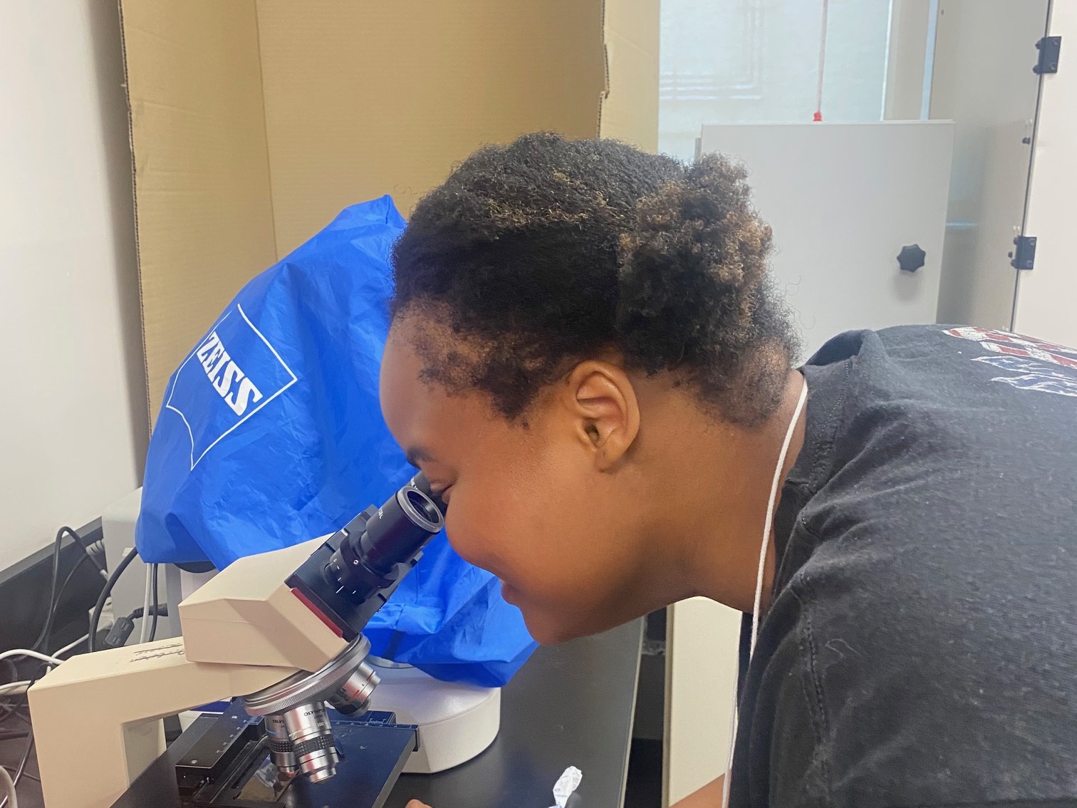 Student peering through a microscope