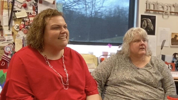 Two women sitting in an office at the Mansfield Campus. They both look to the right of the camera
