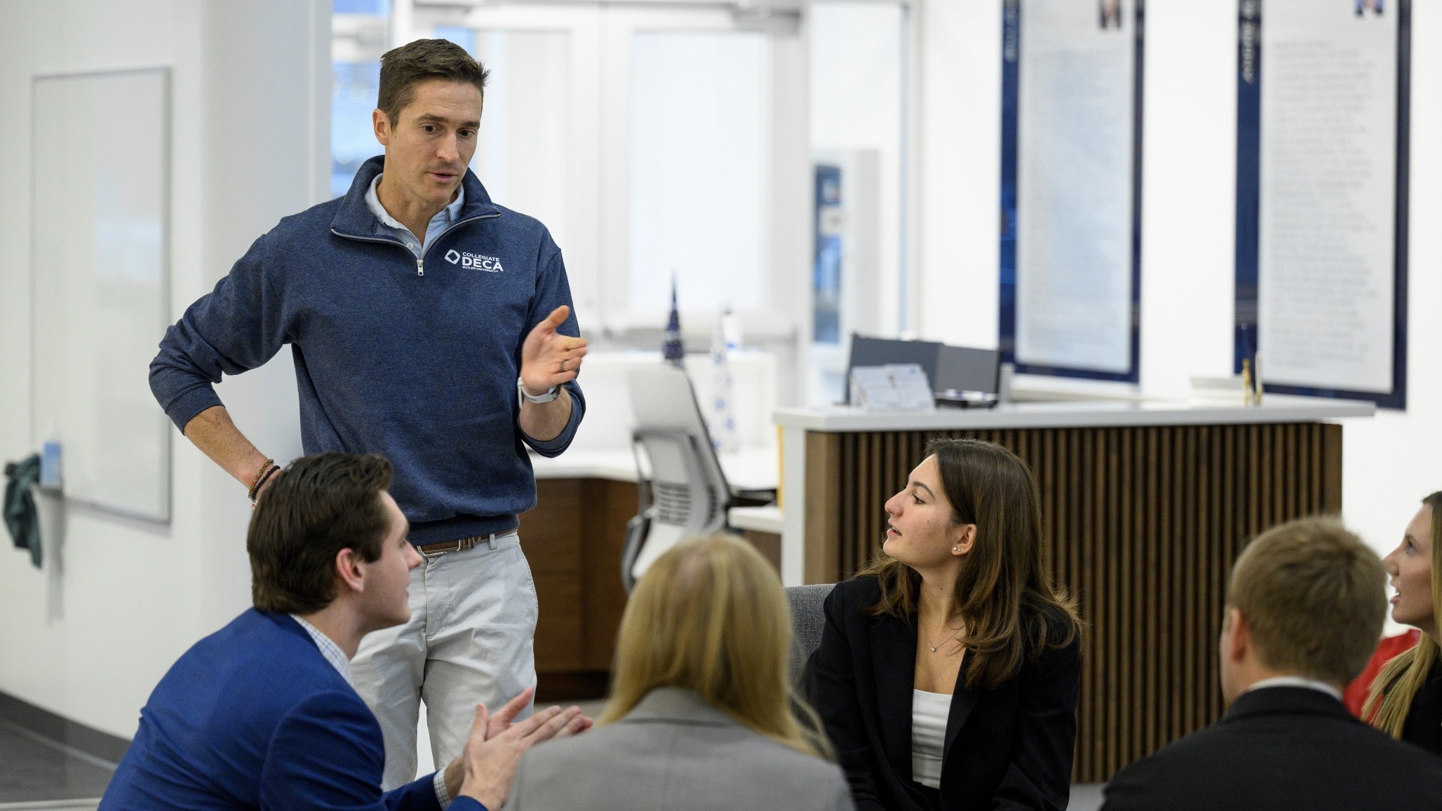 Professor instructing students about their Real Business Experience project
