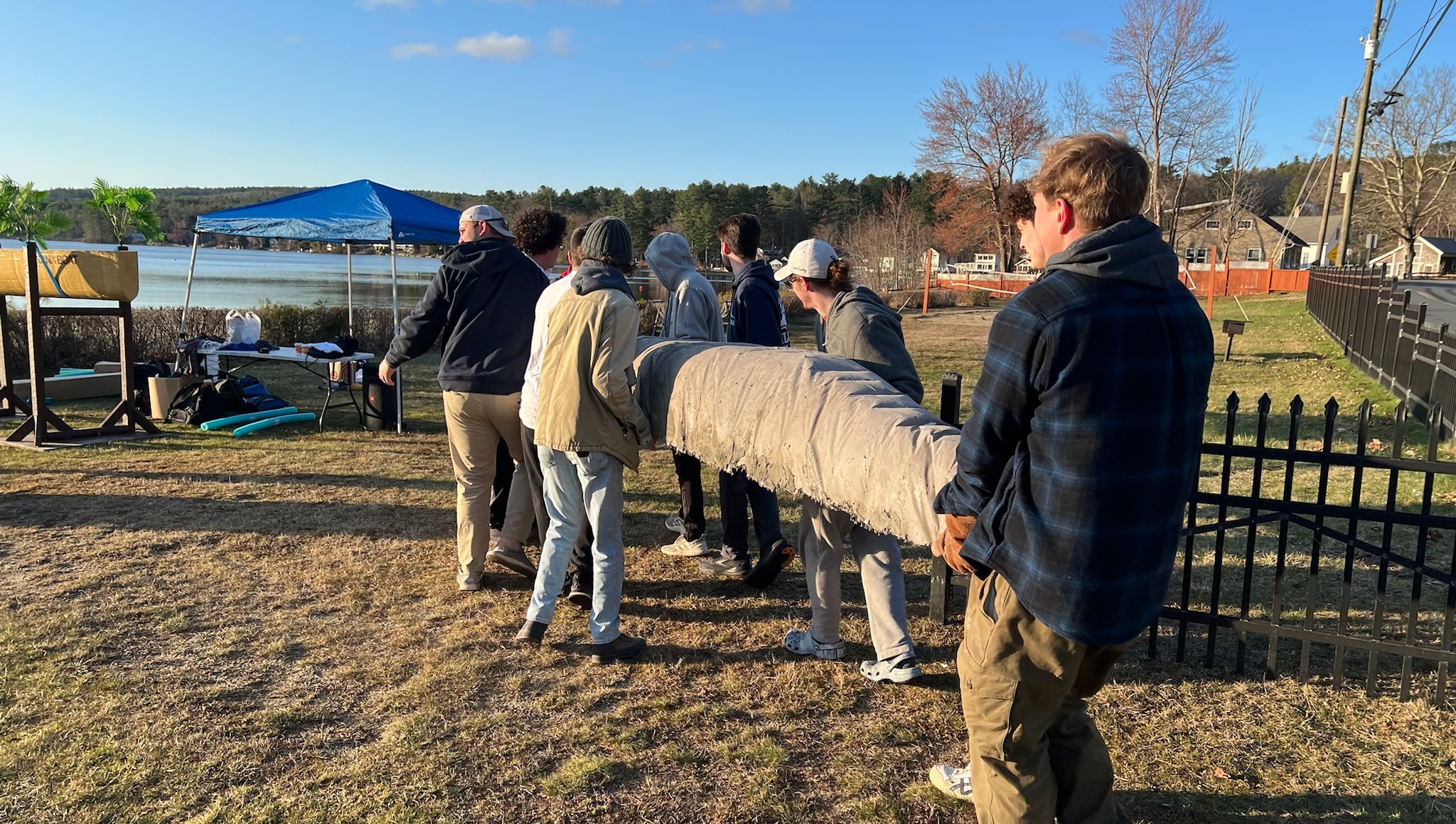 A view of our team carrying the 2025 competition canoe