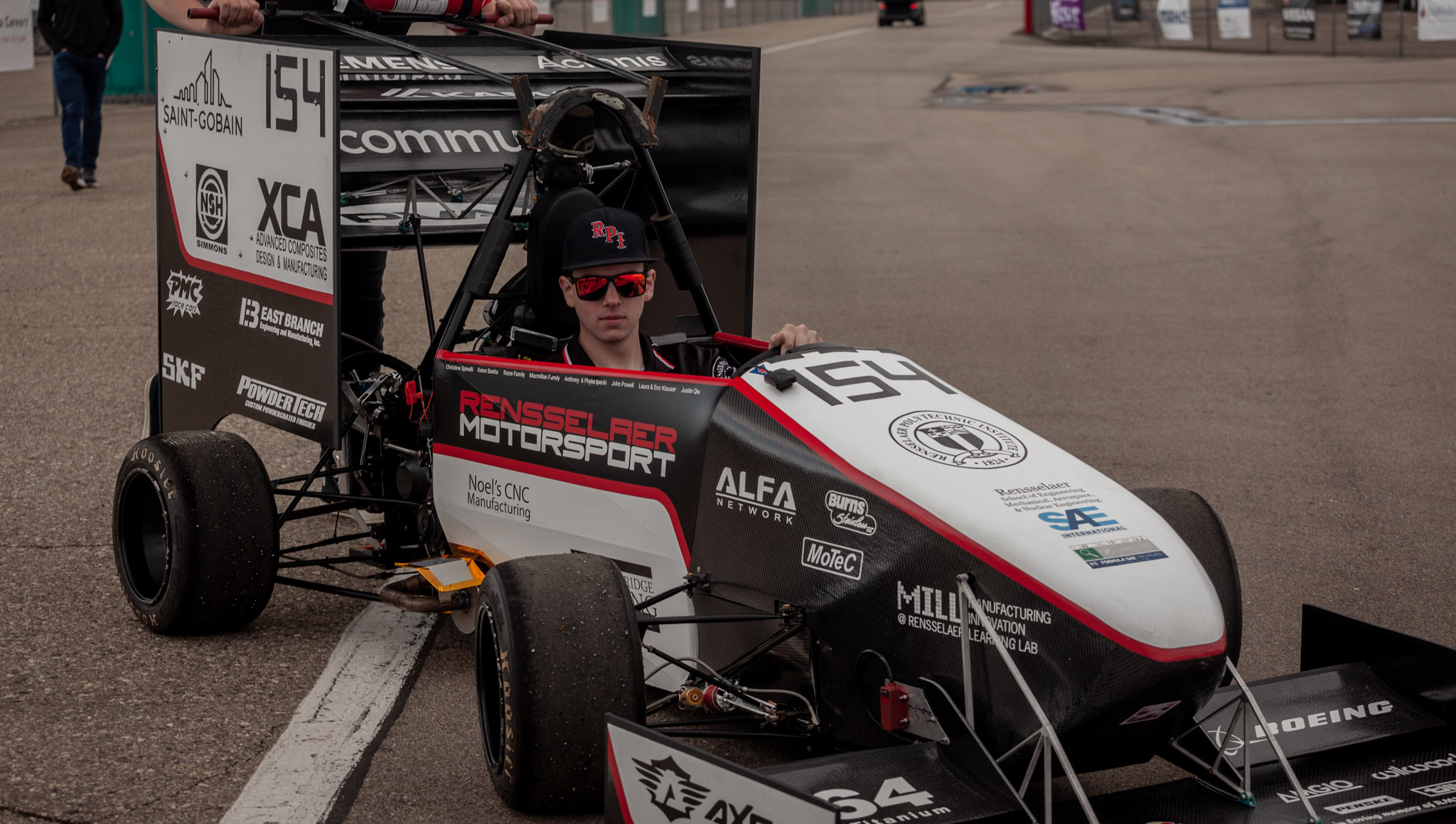 A student sitting in a former Motorsport vehicle.