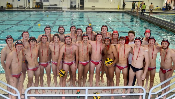 Group of individuals on the Ohio State men's water polo team standing in front of a pool