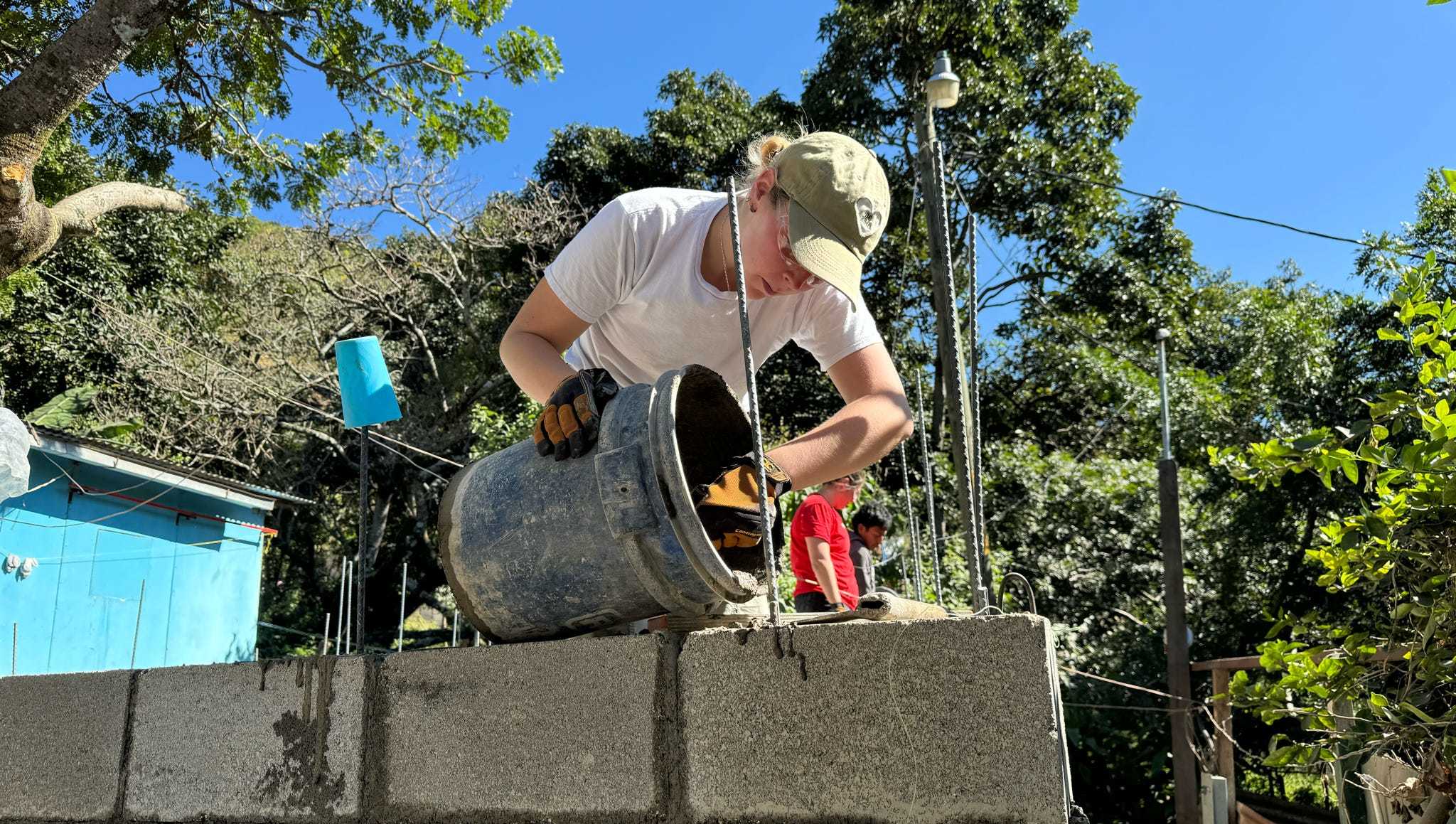 Individuals pouring concrete in Guatemala