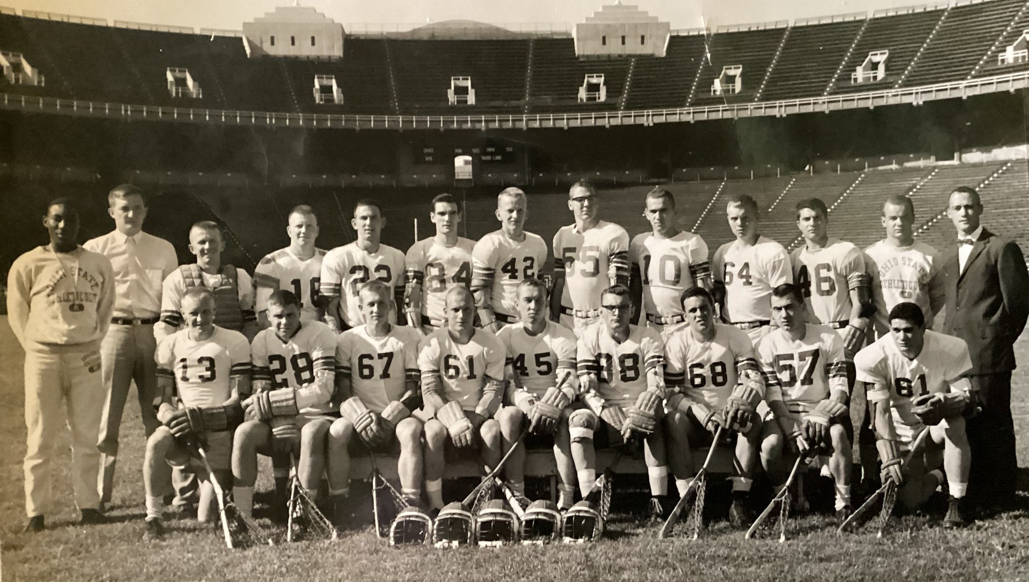 Lacrosse team in a single-file line on the field