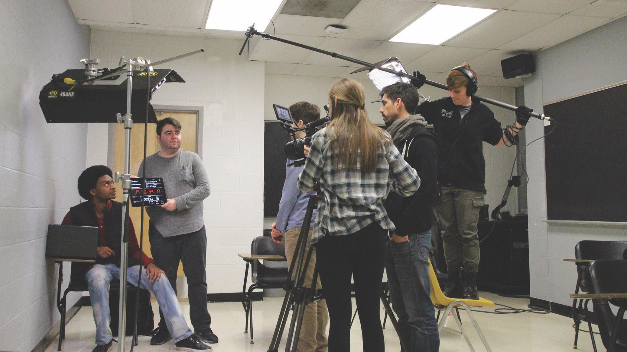 A group of students using filming equipment on a school project.