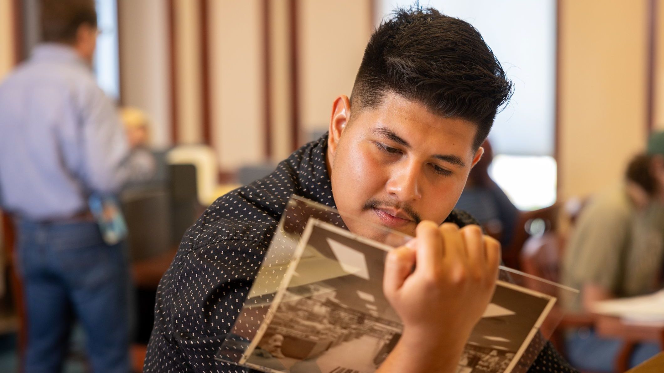 History students examining photos at NAU Special Collections