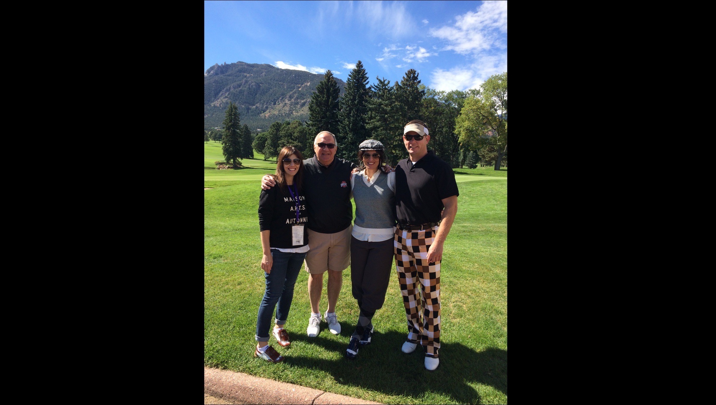 Four golfers posed for a picture on the golf course