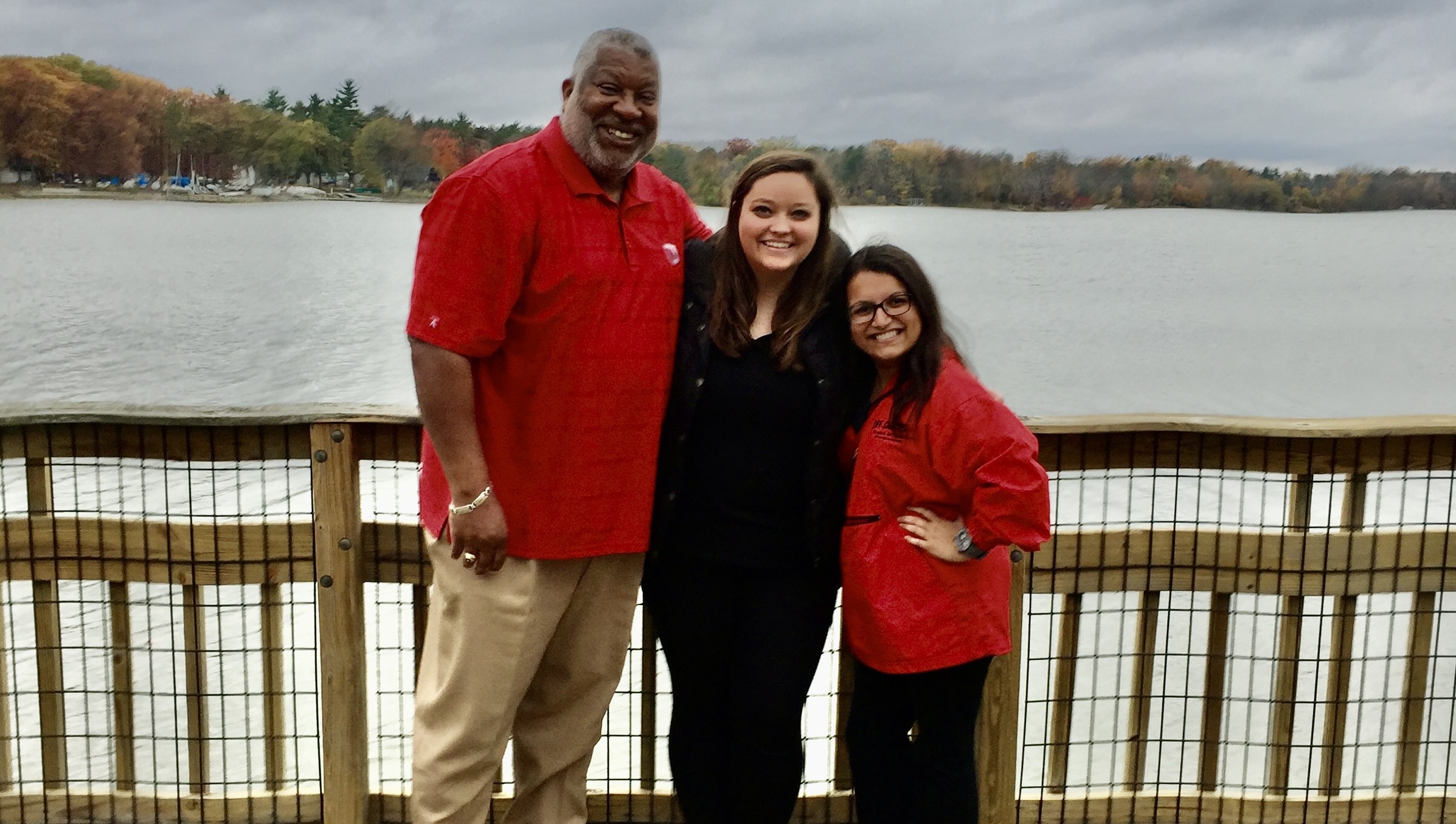 OCCSE team before a fence and body of water