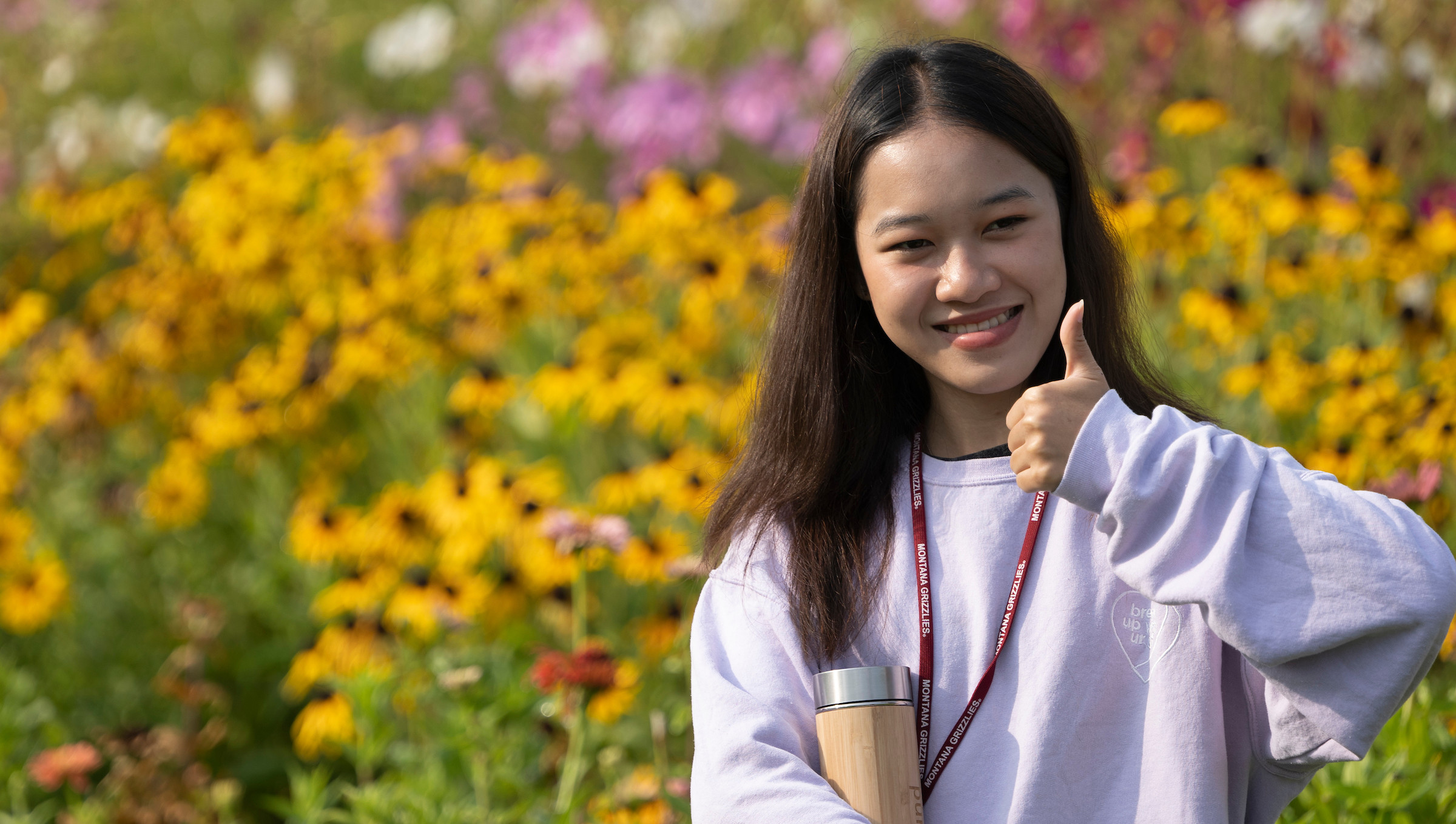 A UM student in sunflower garden