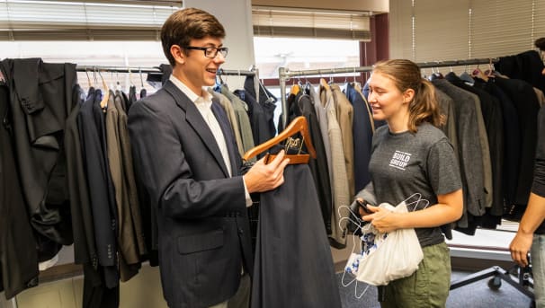 Two students choose clothing