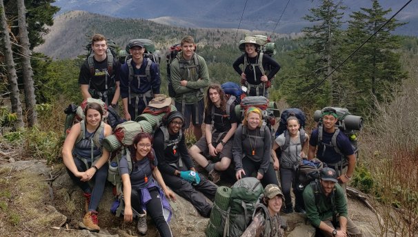 Backpacking students resting on a ridge overlooking Pisgah National Forest near Mt. Mitchell