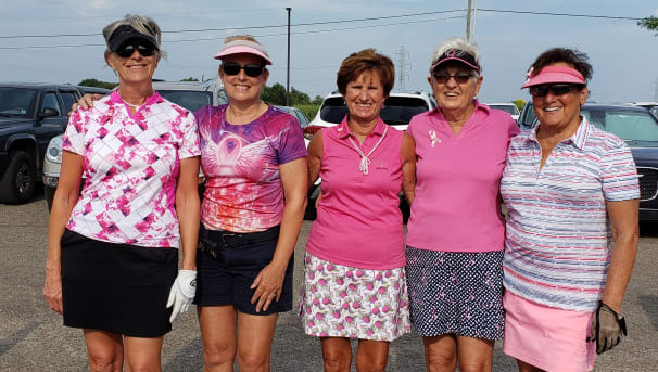 Five golfers standing in a parking lot for the Stefanie Spielman Fund for breast cancer research