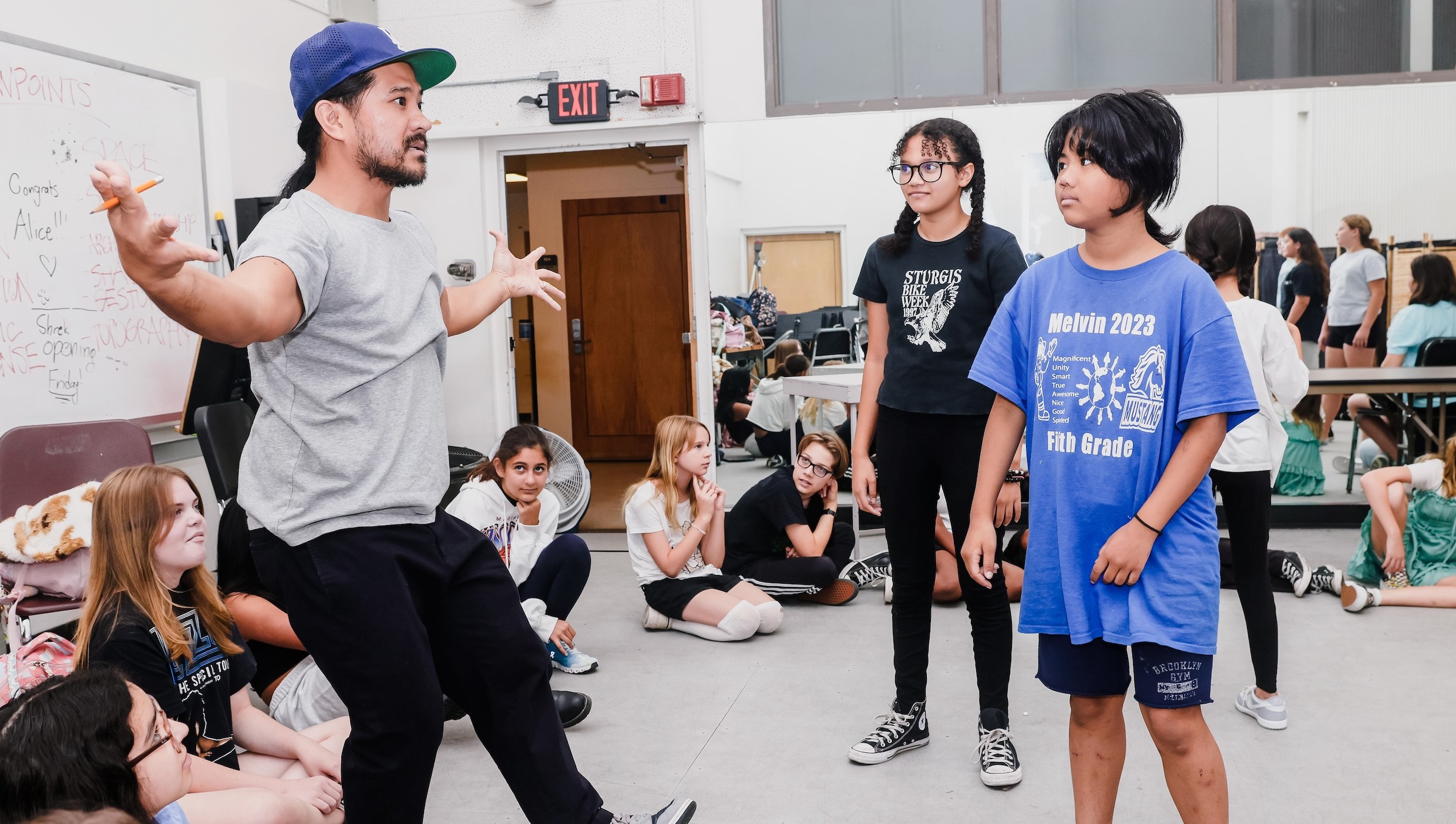 Ed Refuerzo demonstrates a gesture to Acting students.
