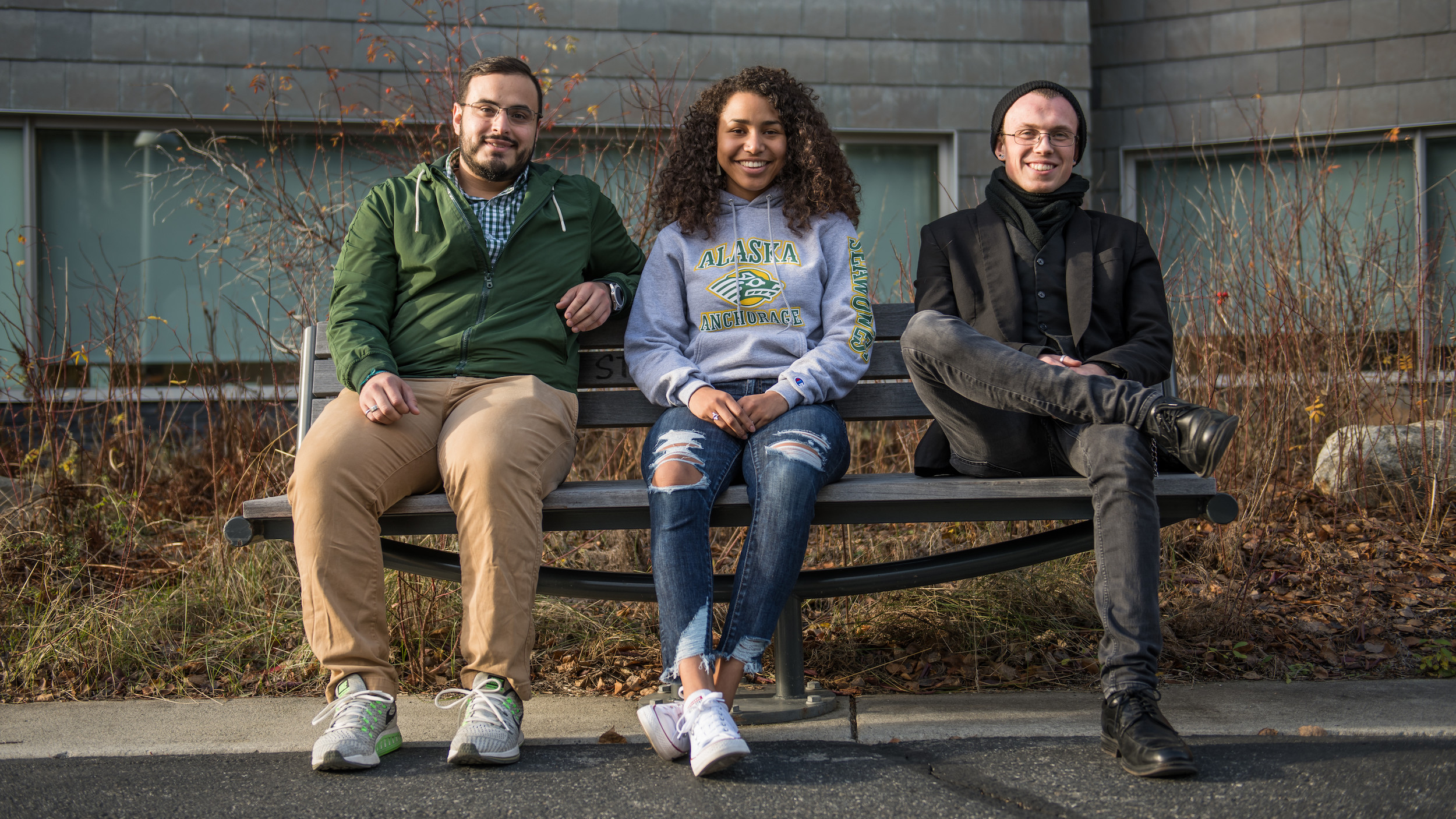 three students sitting on bench, scholarship recipients