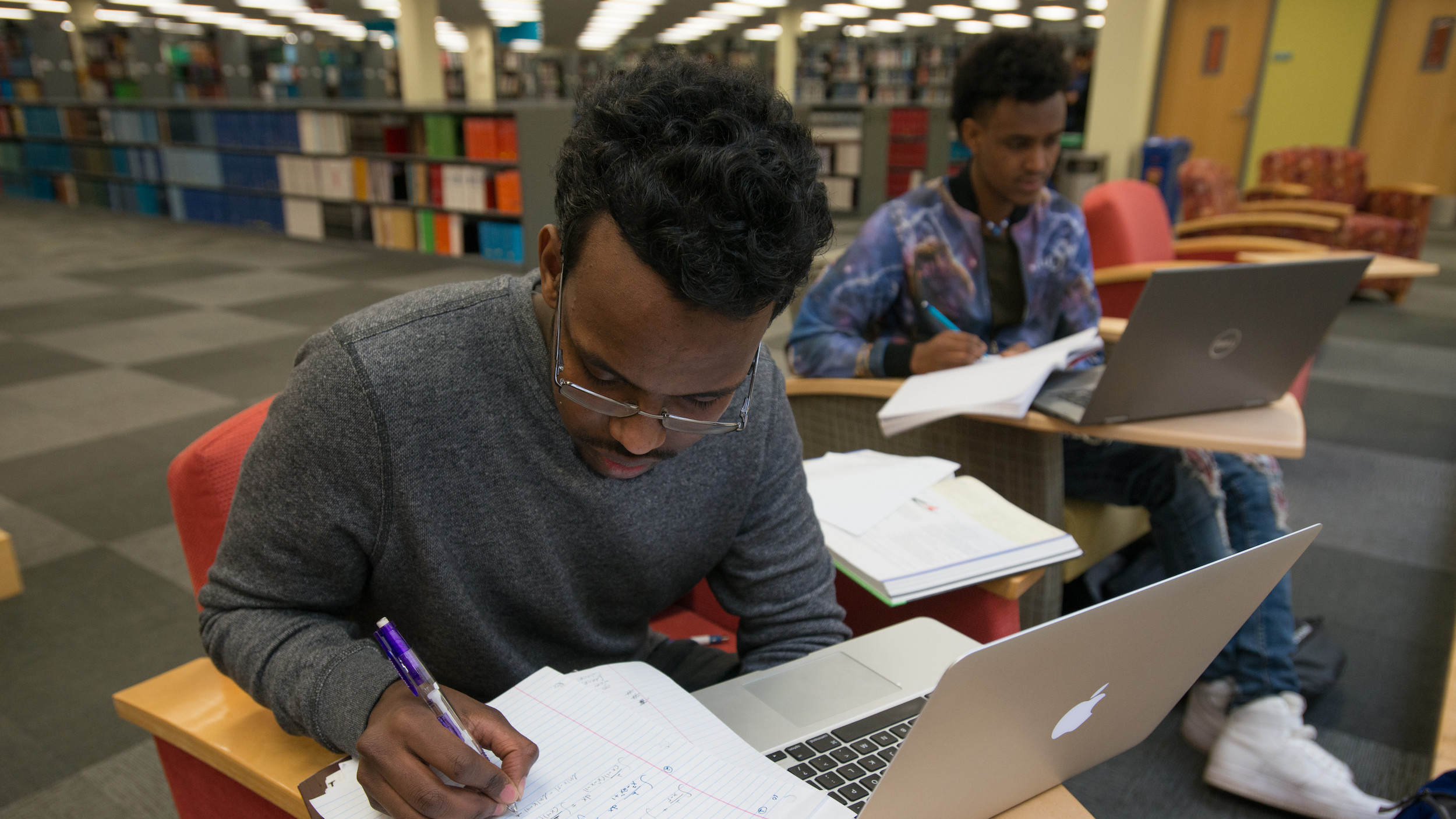 2 Students study in library