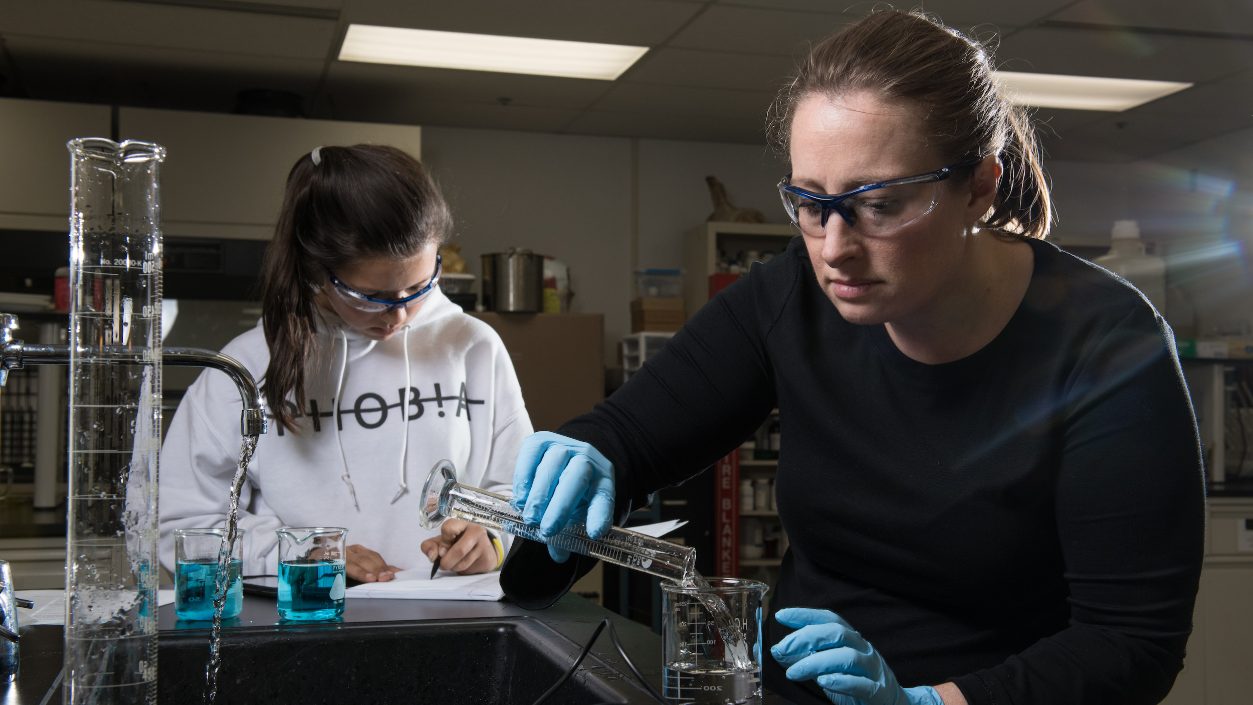 Jennifer Smith and Emily Larson prepare a lab experiment in chemistry course at Kodiak College