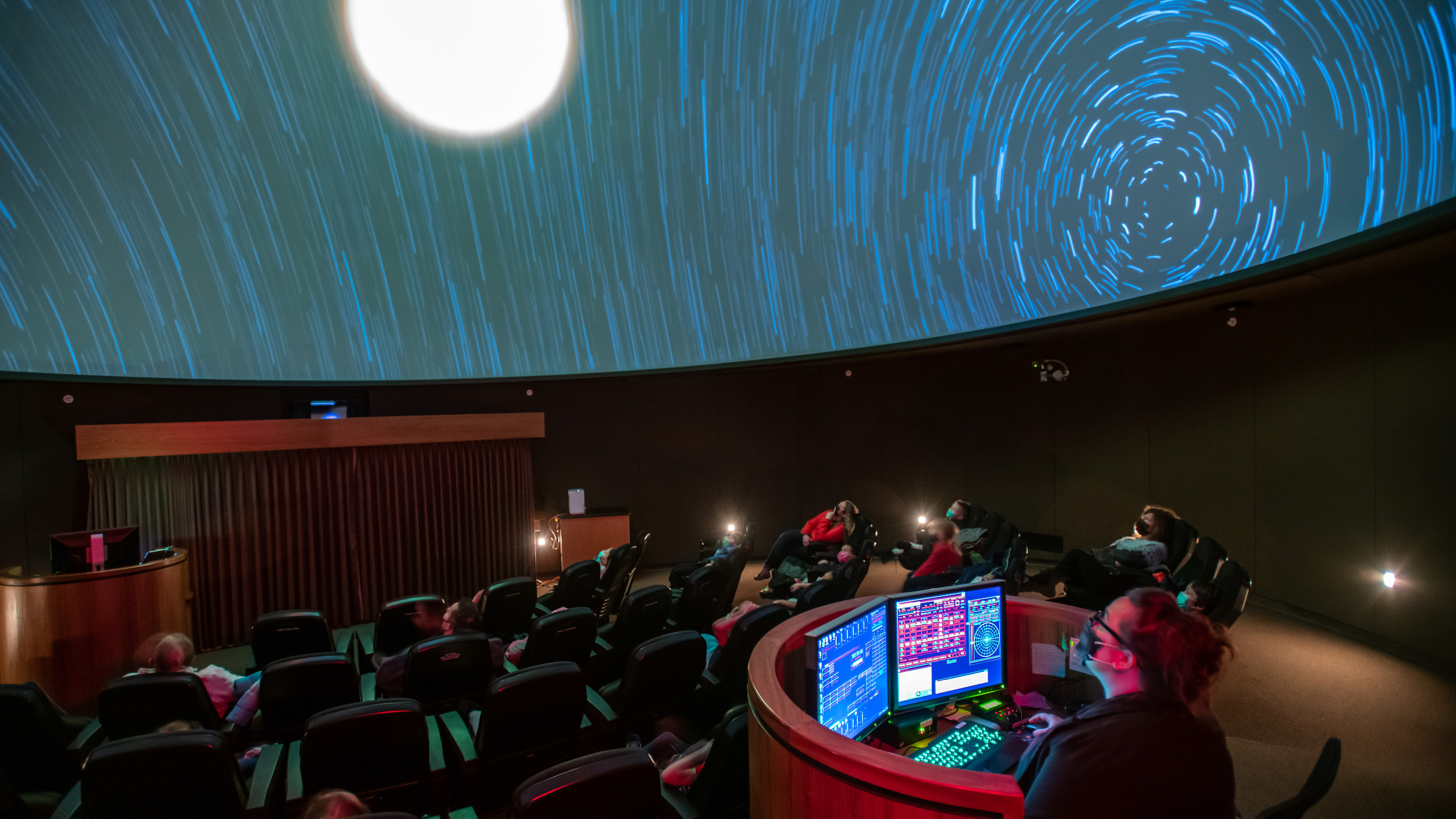 Planetarium Image of stars (swirling) and planet