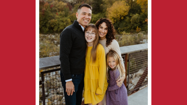 Erika Bray with her husband and two daughters posing on a bridge