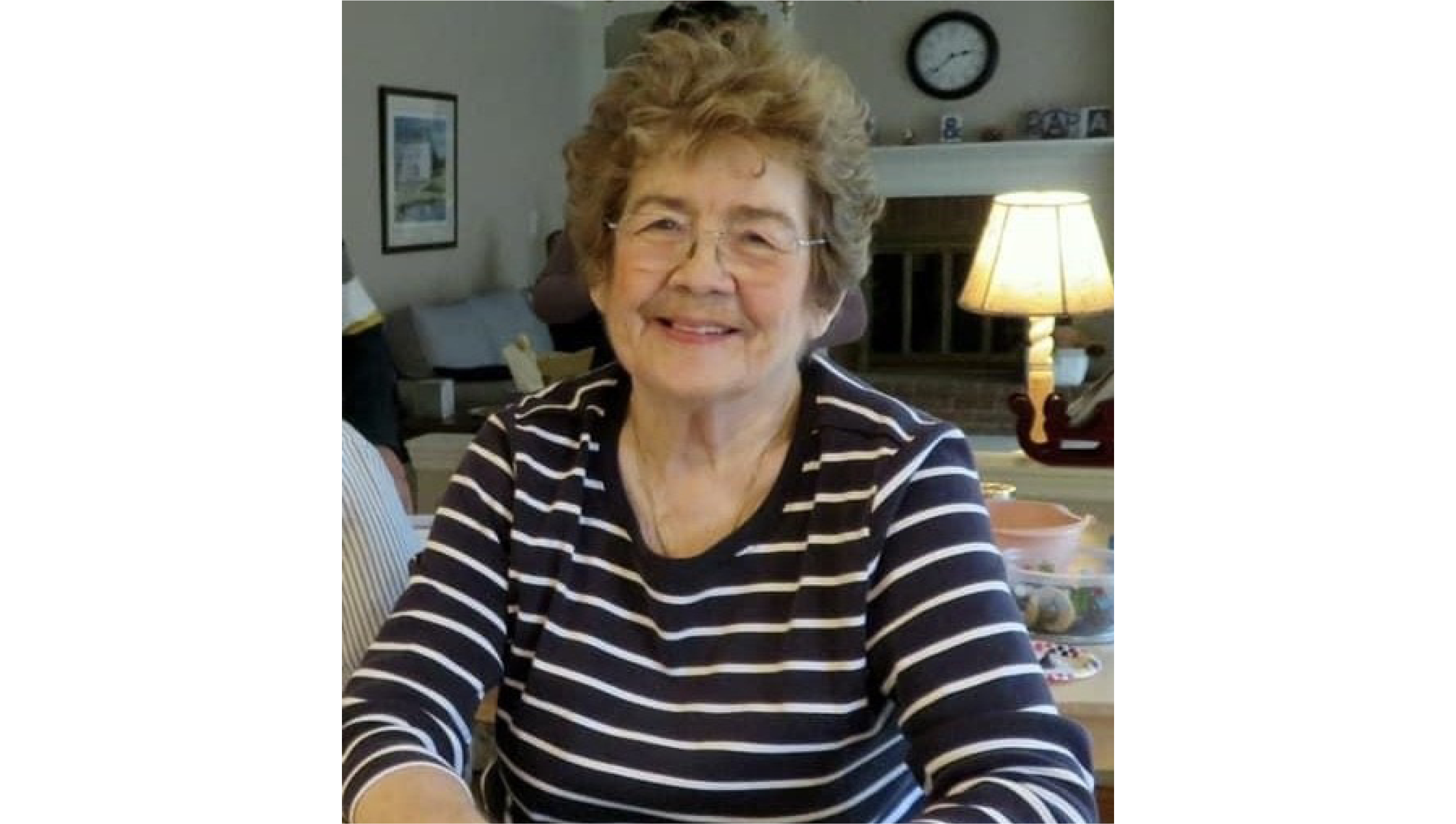 Nan Elaine Grandstaff wearing striped shirt and smiling at camera