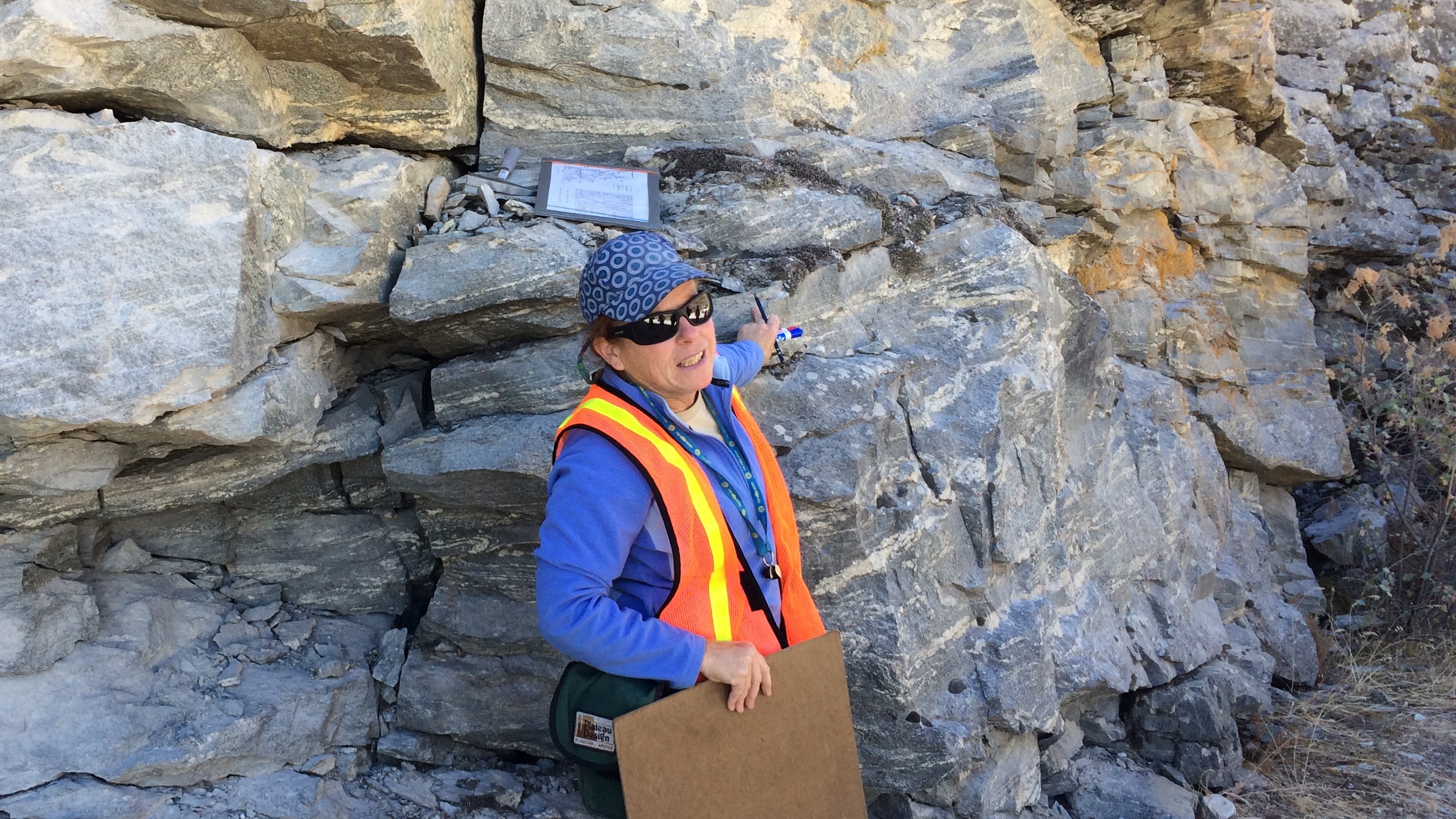 Professor Liz Schermer lectures in front of a rock formation for Geology 318, Structural Geology