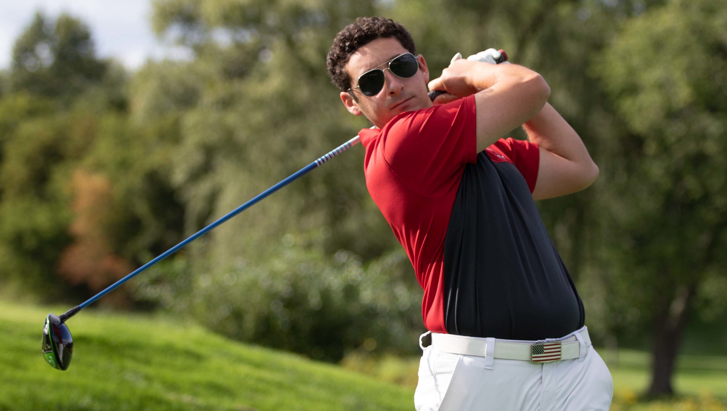 An RPI golf player swinging the club.