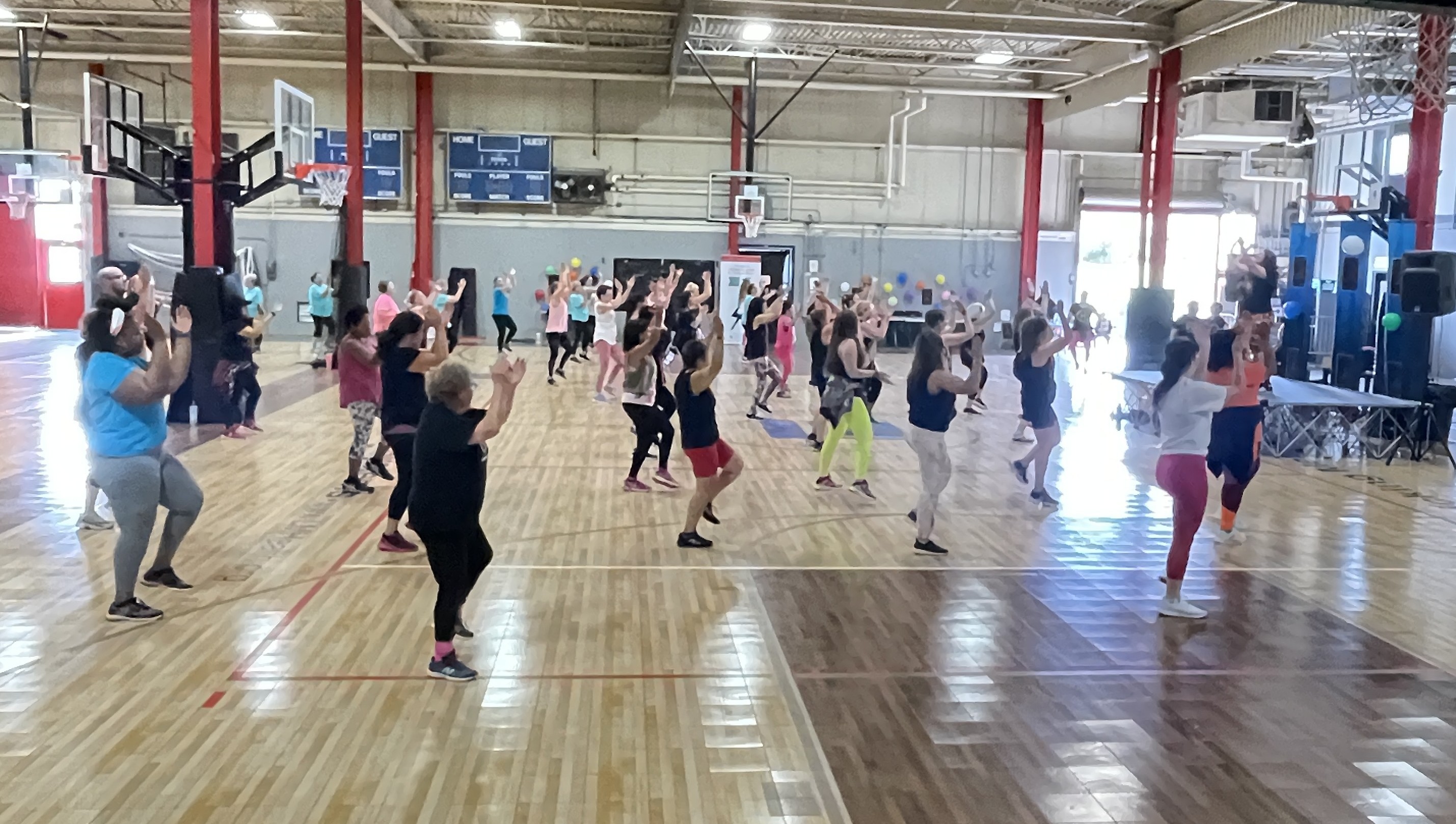 Group clapping in unison at a gym