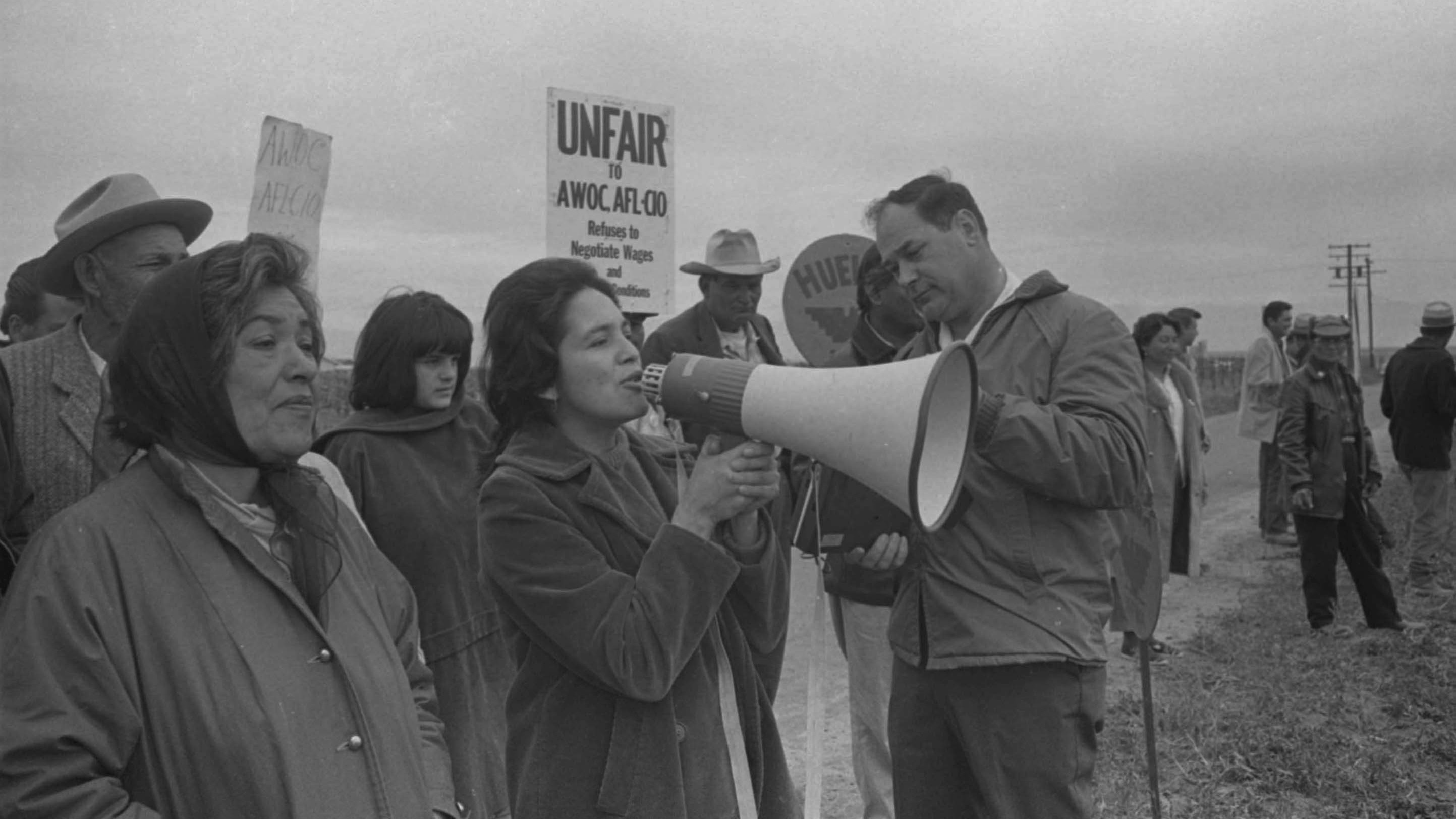Women speaking in the megaphone during a protest.