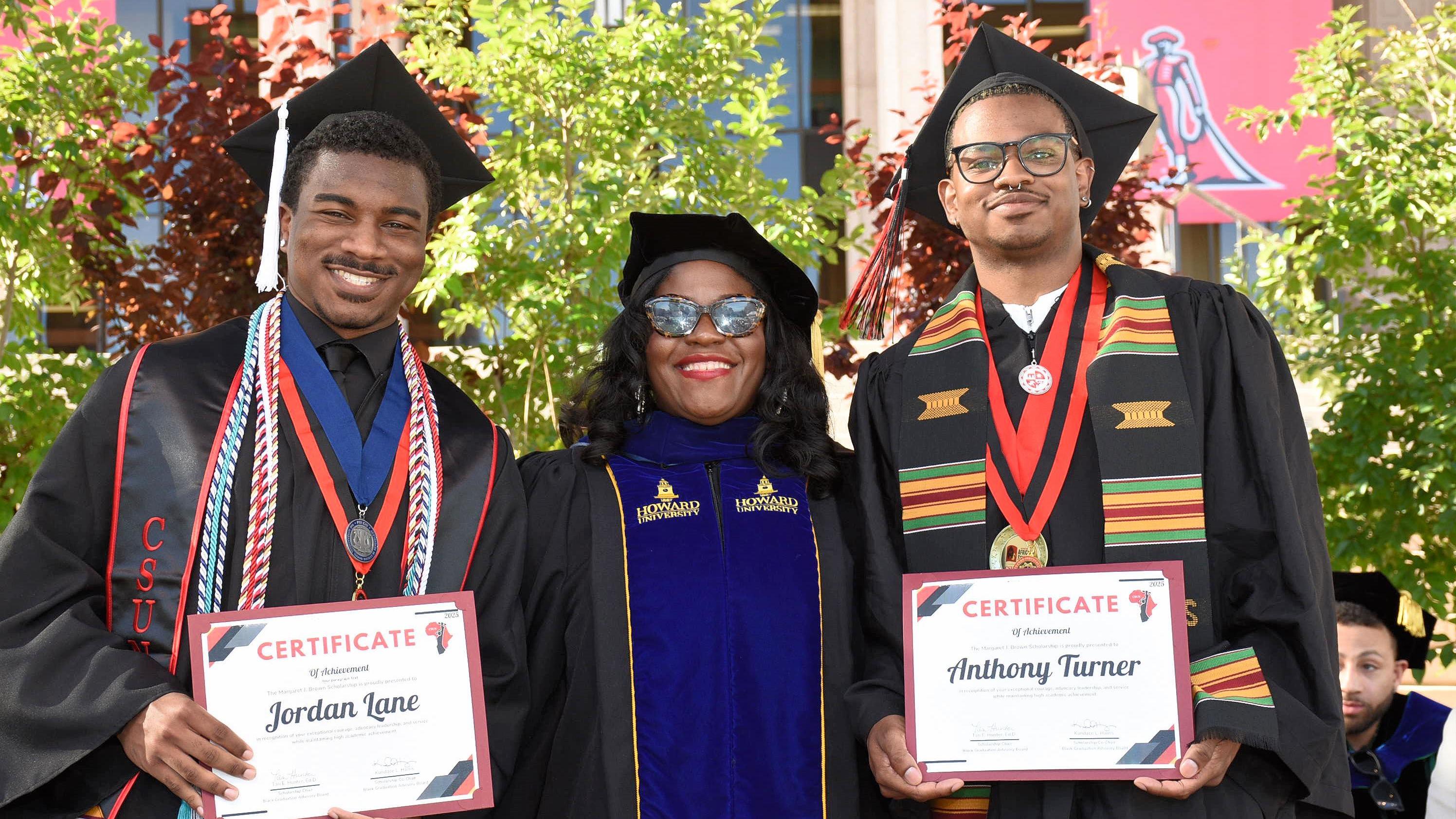 Students posing in graduation regalia
