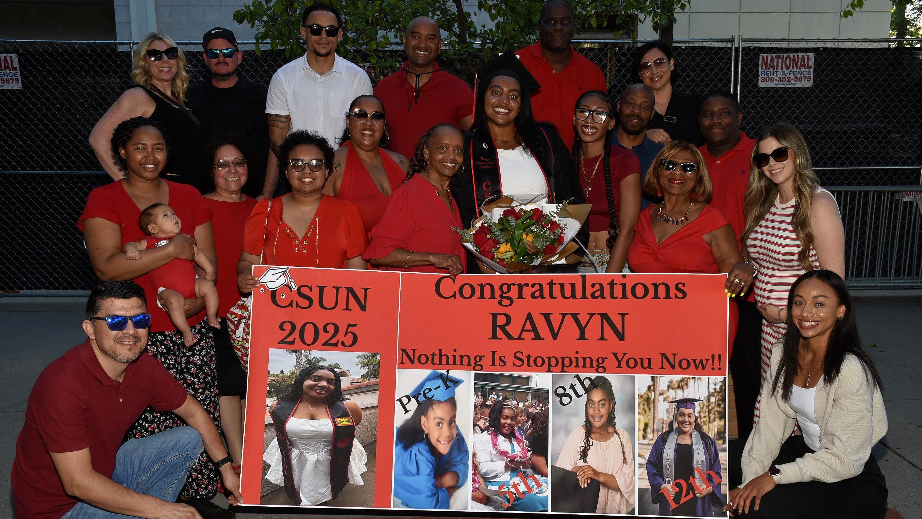 People posing with poster saying, "CSUN 2025, Congratulations, Ravyn, Nothing is Stopping You Now!"