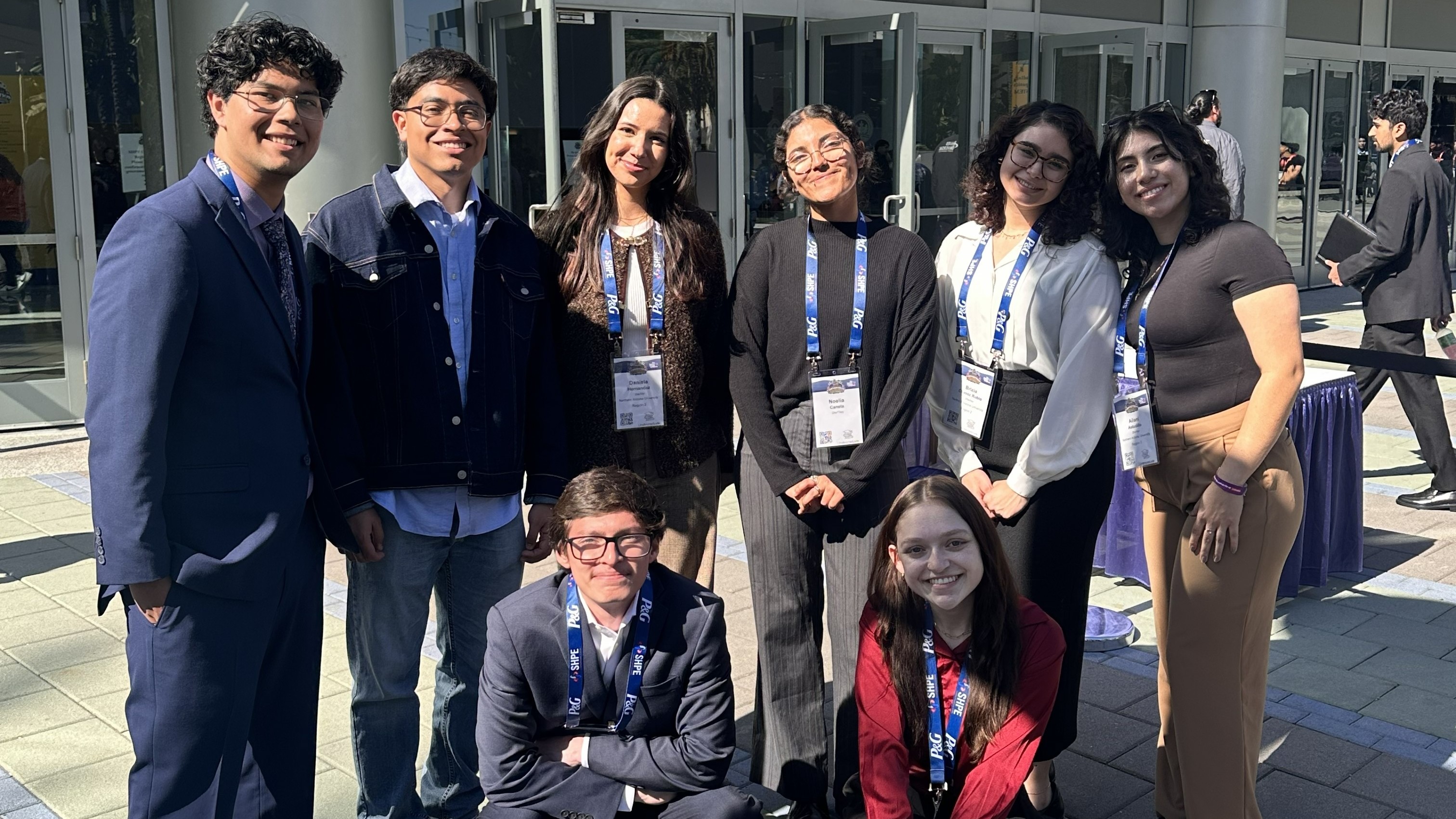 Eight members standing in front of the Anaheim Convention Center during the 2024 SHPE National Conve