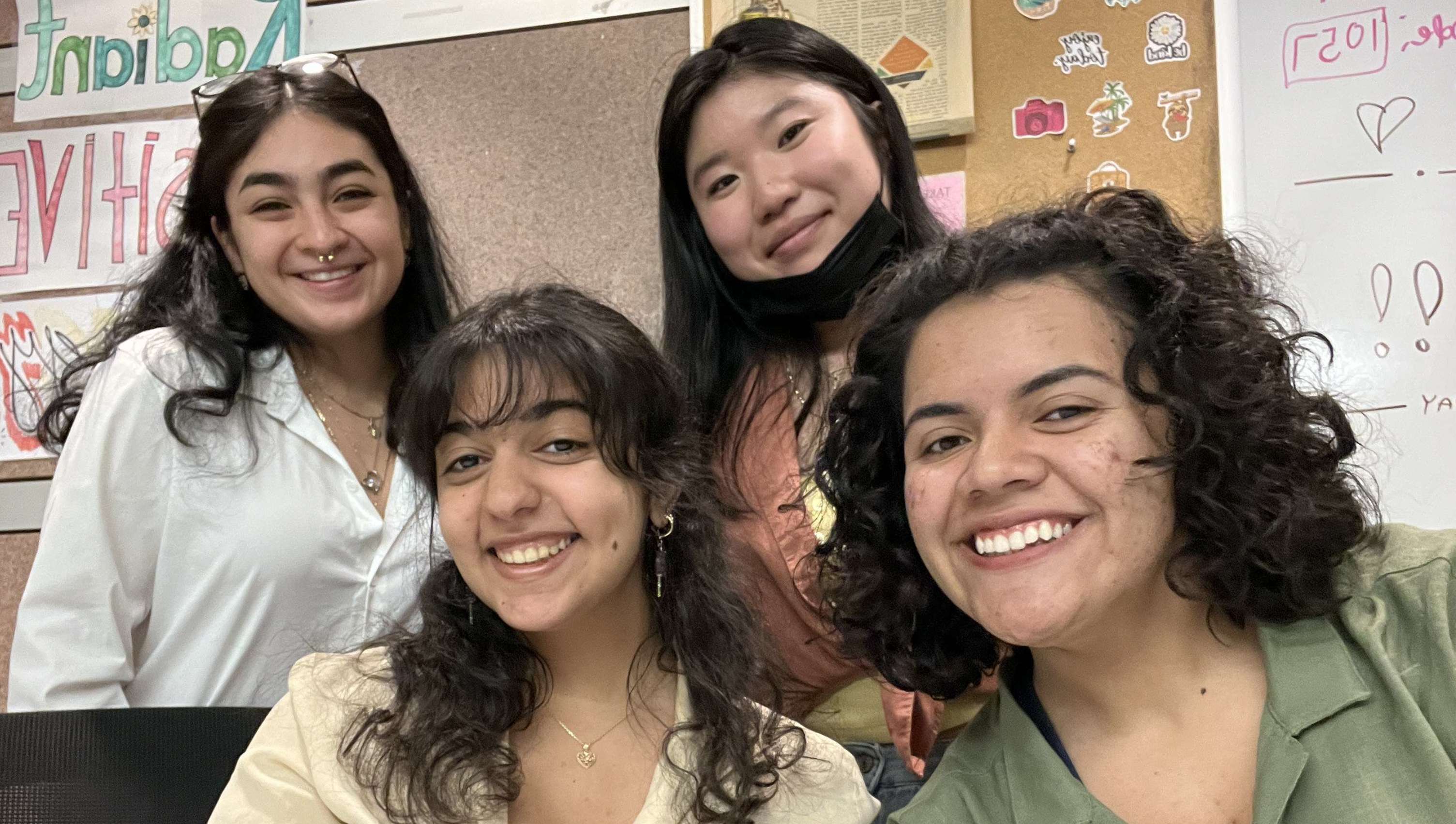 Close up picture of four BSP students smiling in the BSP room.