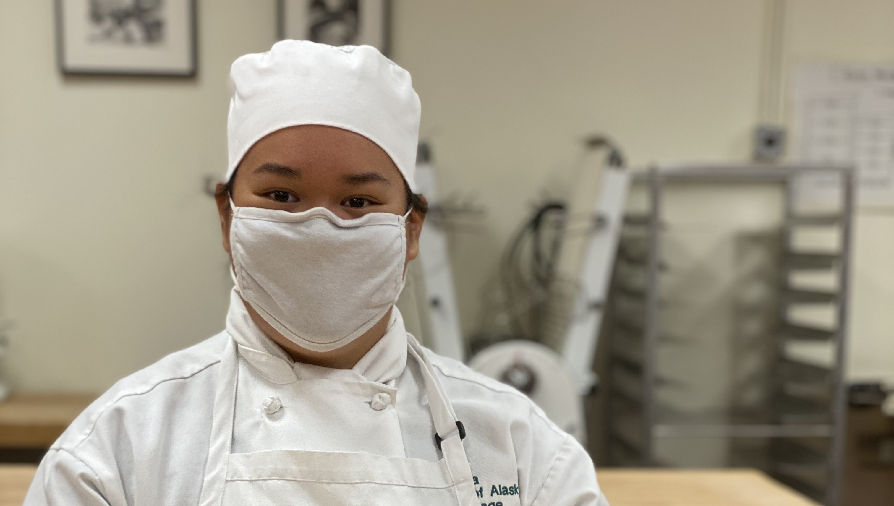 Chef wearing a mask and looking at the camera