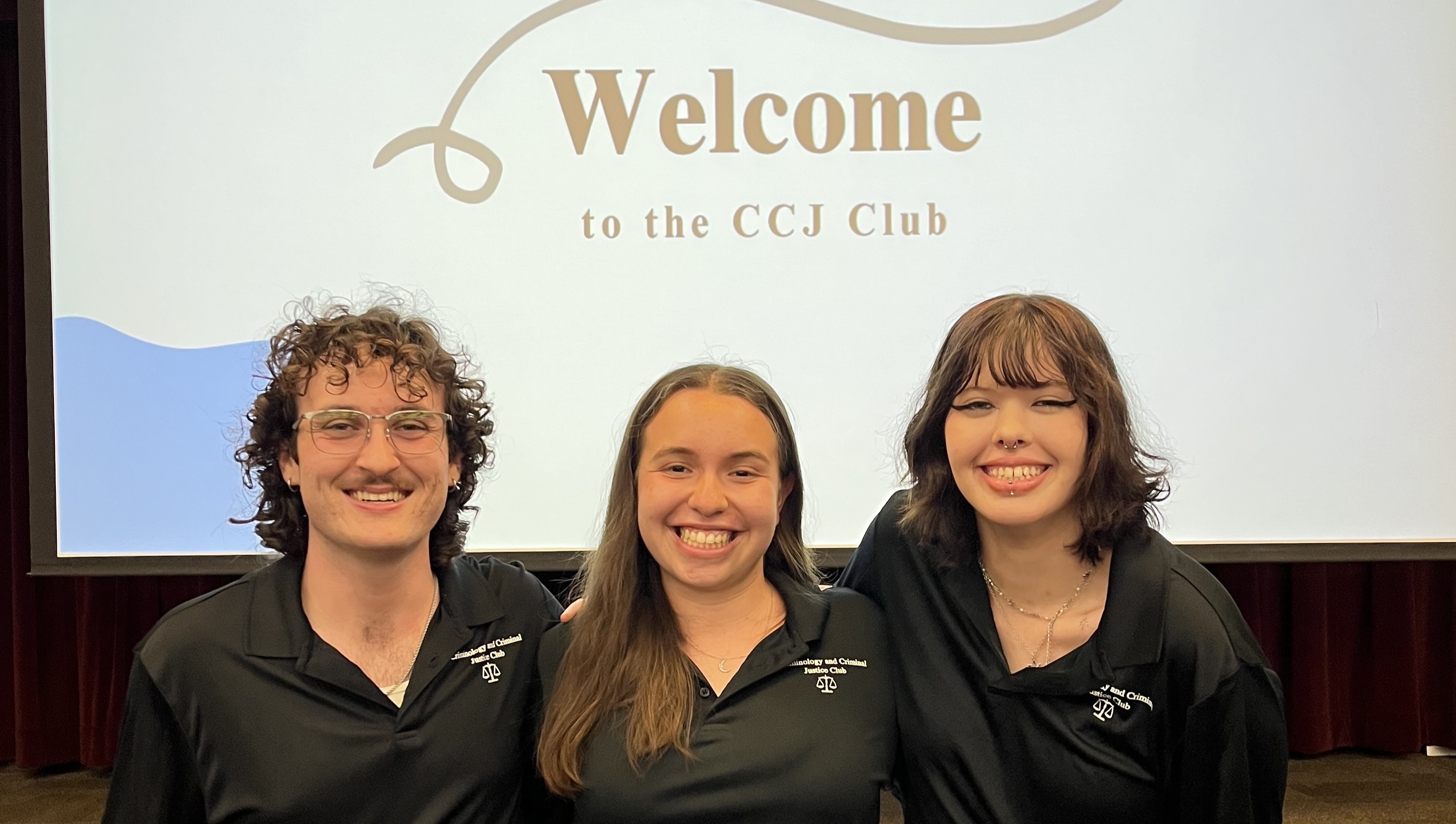 Three CCJ Club members posed together in their club polos.