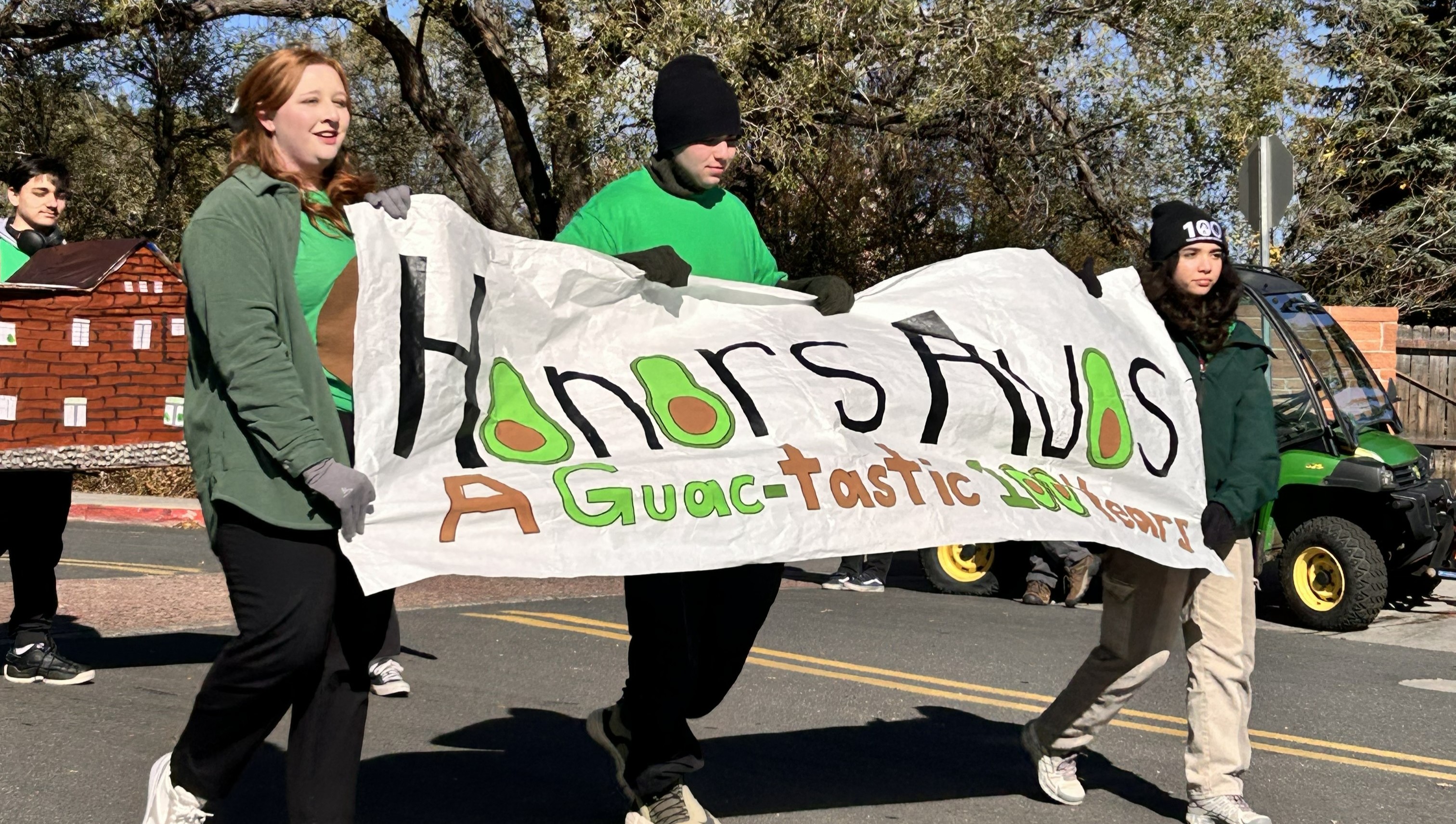 Honors Community Council carrying a sign at the 2024 Homecoming Parade.