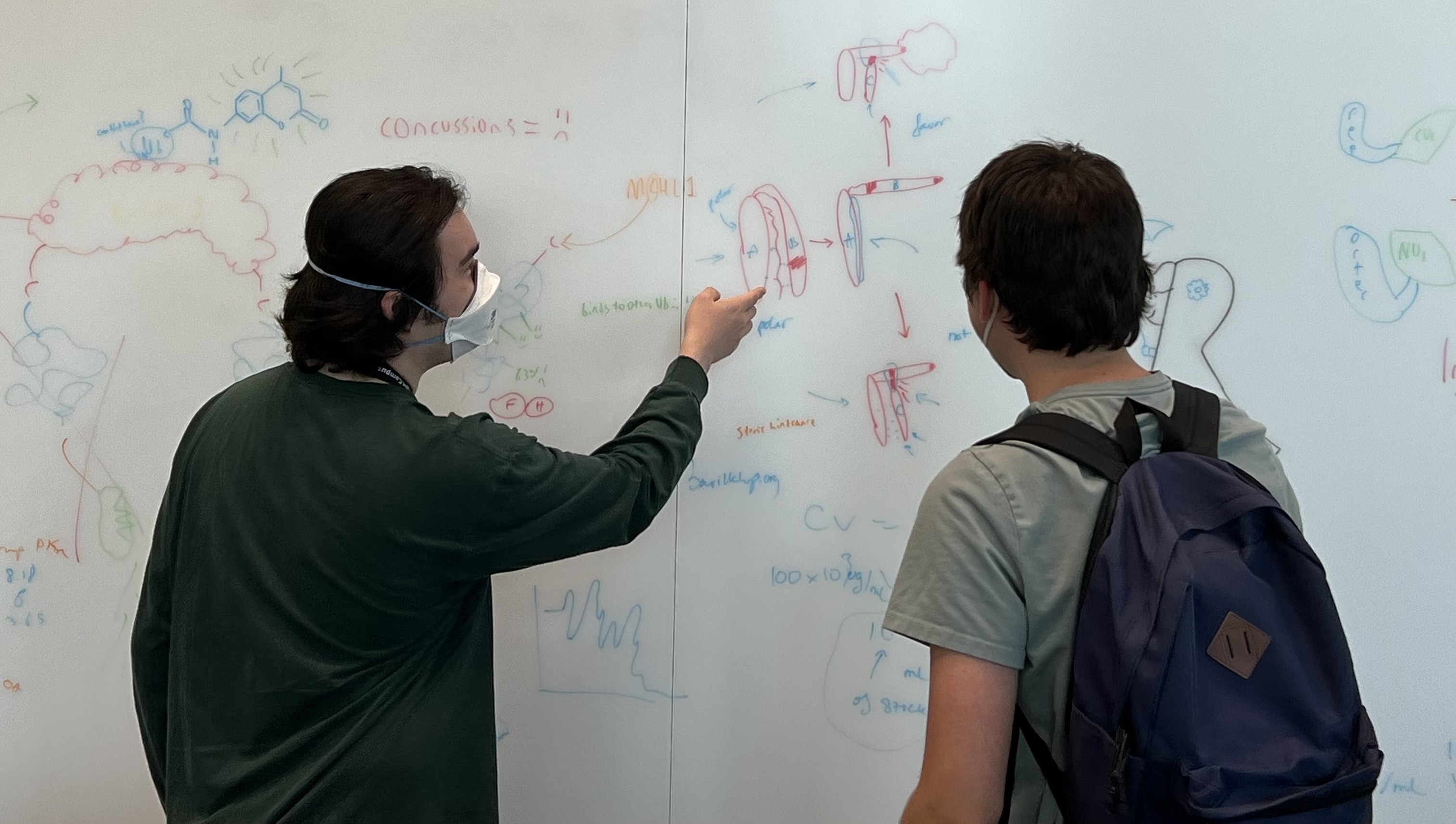 Oliver (left) explaining the biosensor design